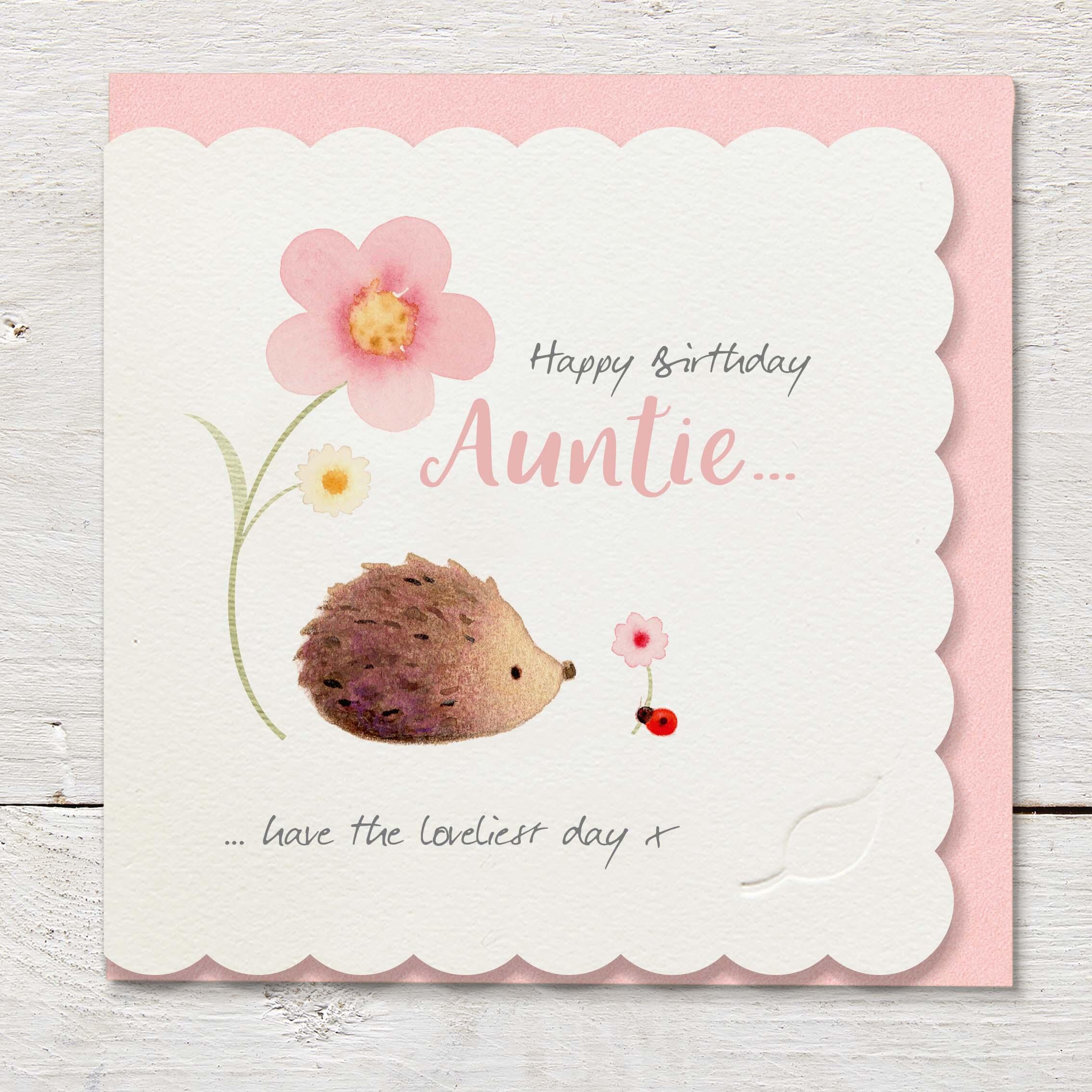 Die cut cardfeaturing a large pink flower, hedgehog and ladybird.