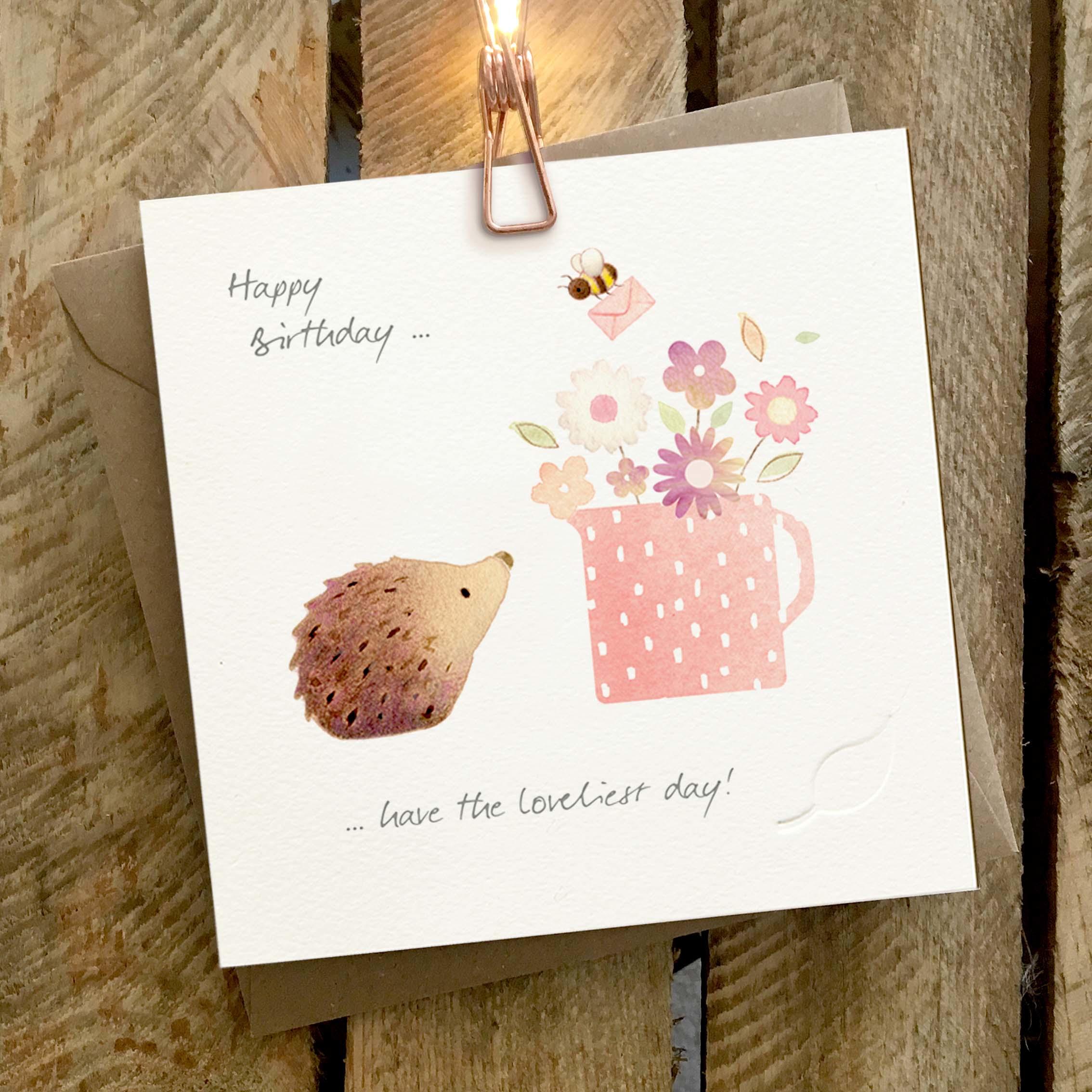 Card featuring a cute hedgehog and bee with a spotted jug of flowers.