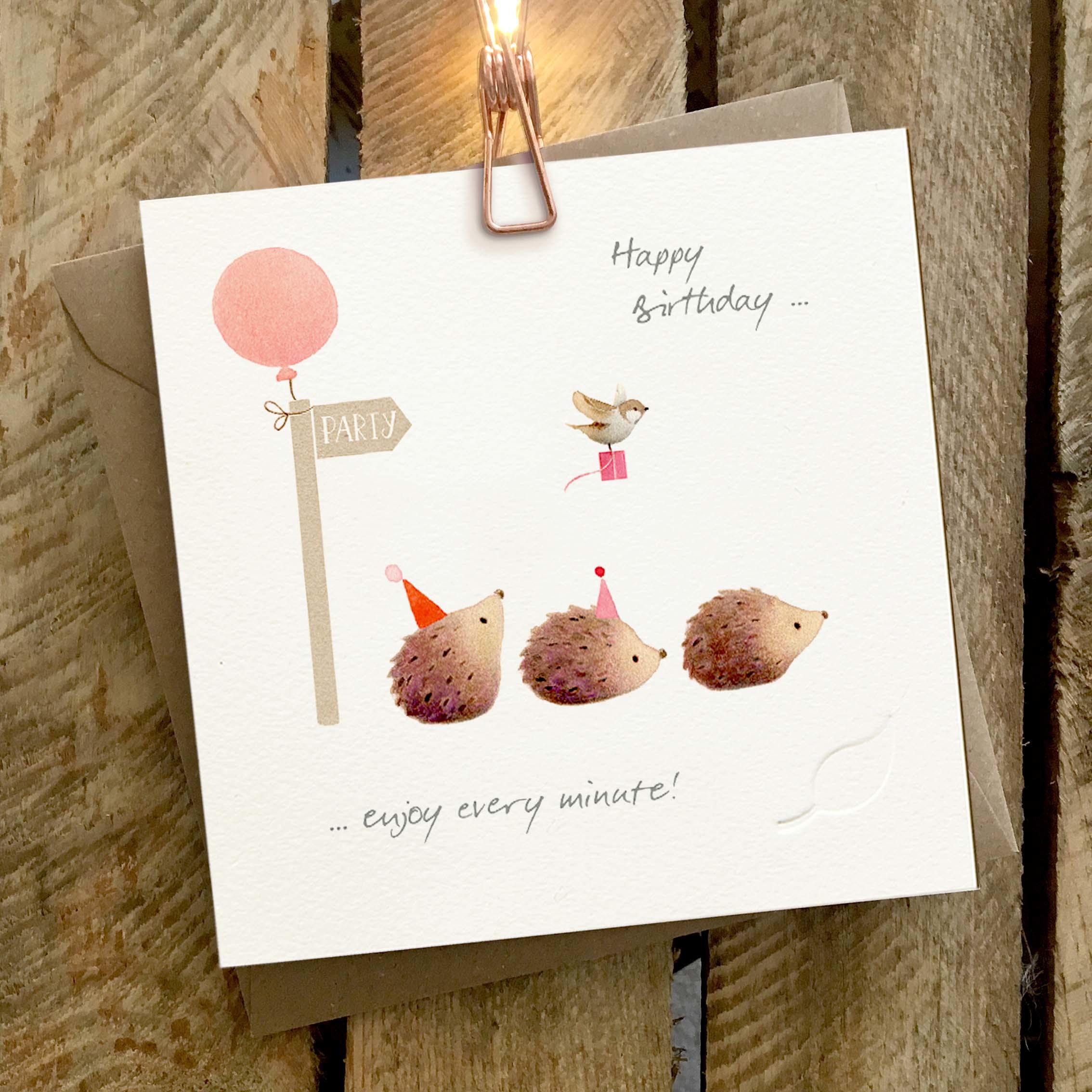 Card featuring a party sign, and three cute hedgehogs on the way to a party.