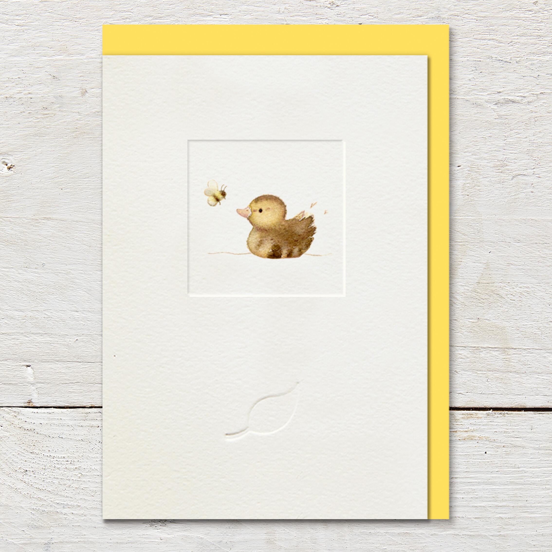 Card featuring an illustration of a little duckling and bumble bee, in the middle of a small debossed window panel. Card is left blank for an open send.