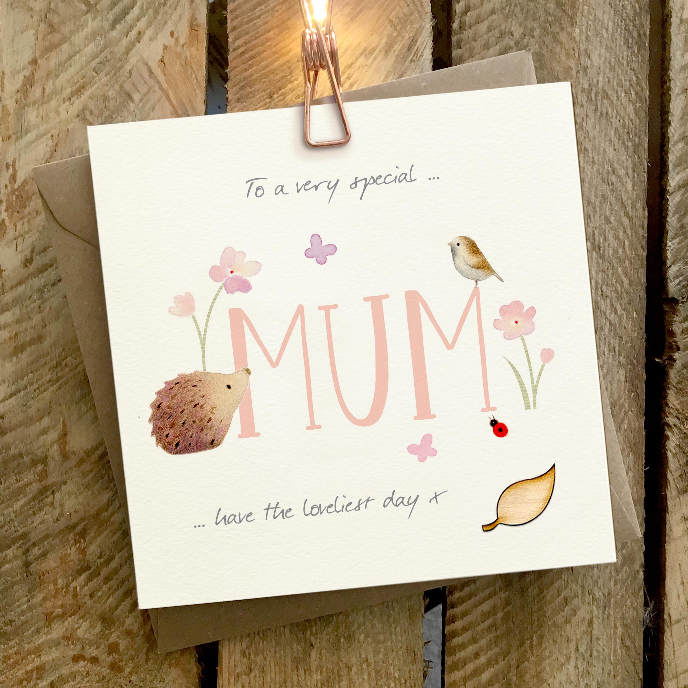 Card featuring an illustrated hedgehog and little bird sitting on a large 'MUM' caption.