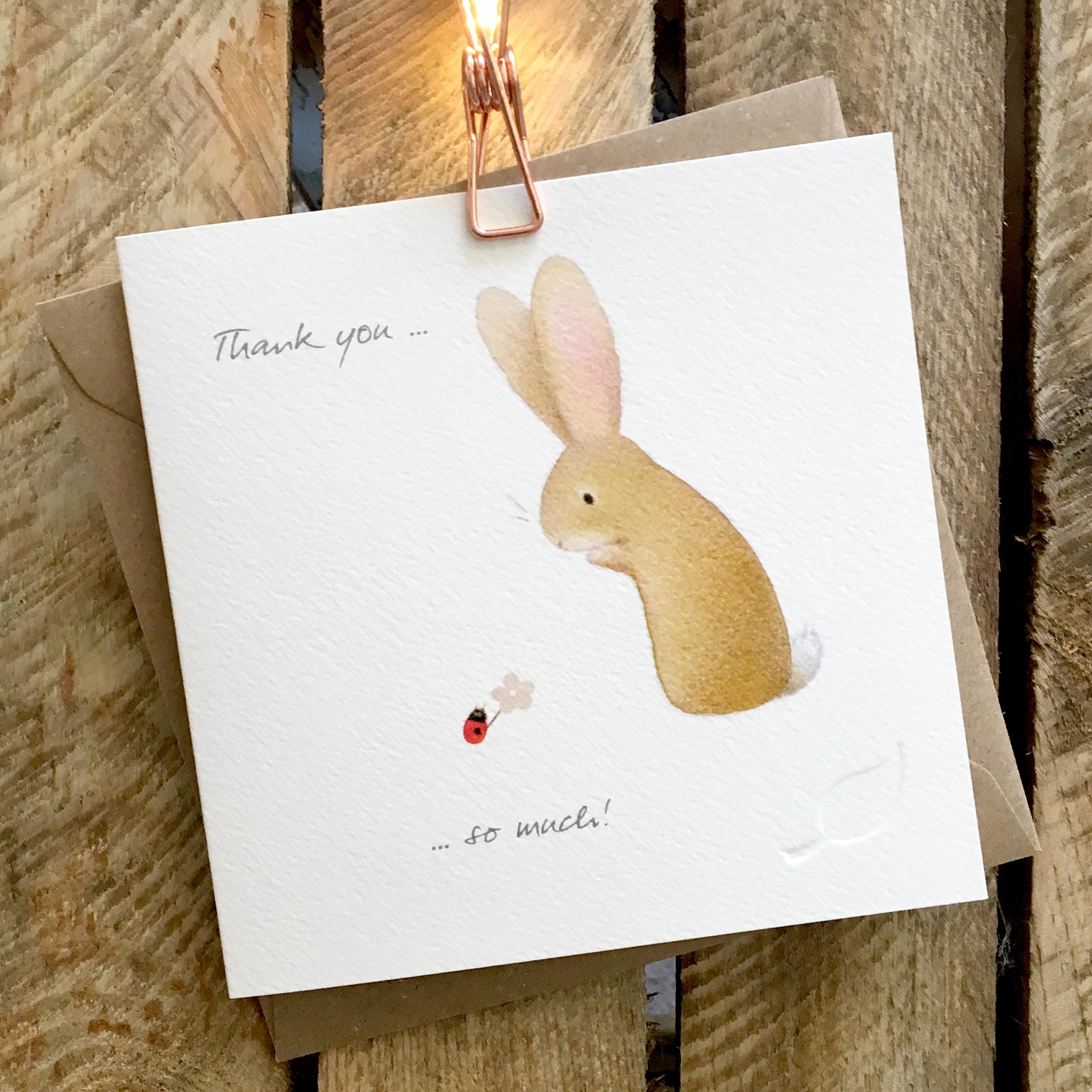 Card featuring a cute rabbit looking at a ladybird holding a small flower