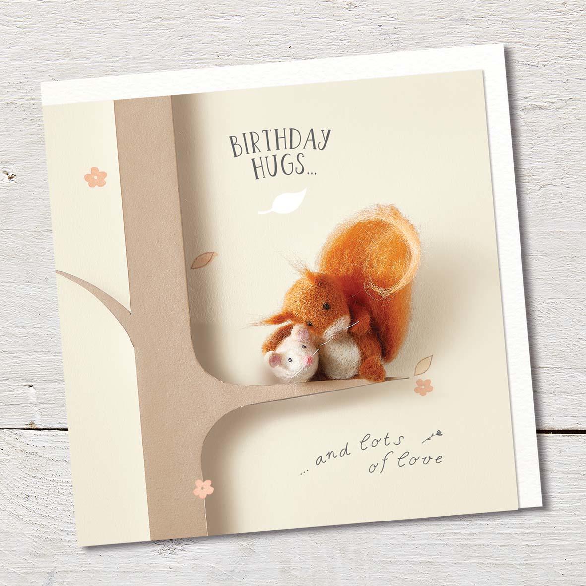 Card featuring a cute felted red squirrel and a tiny mouse hugging on a tree branch.