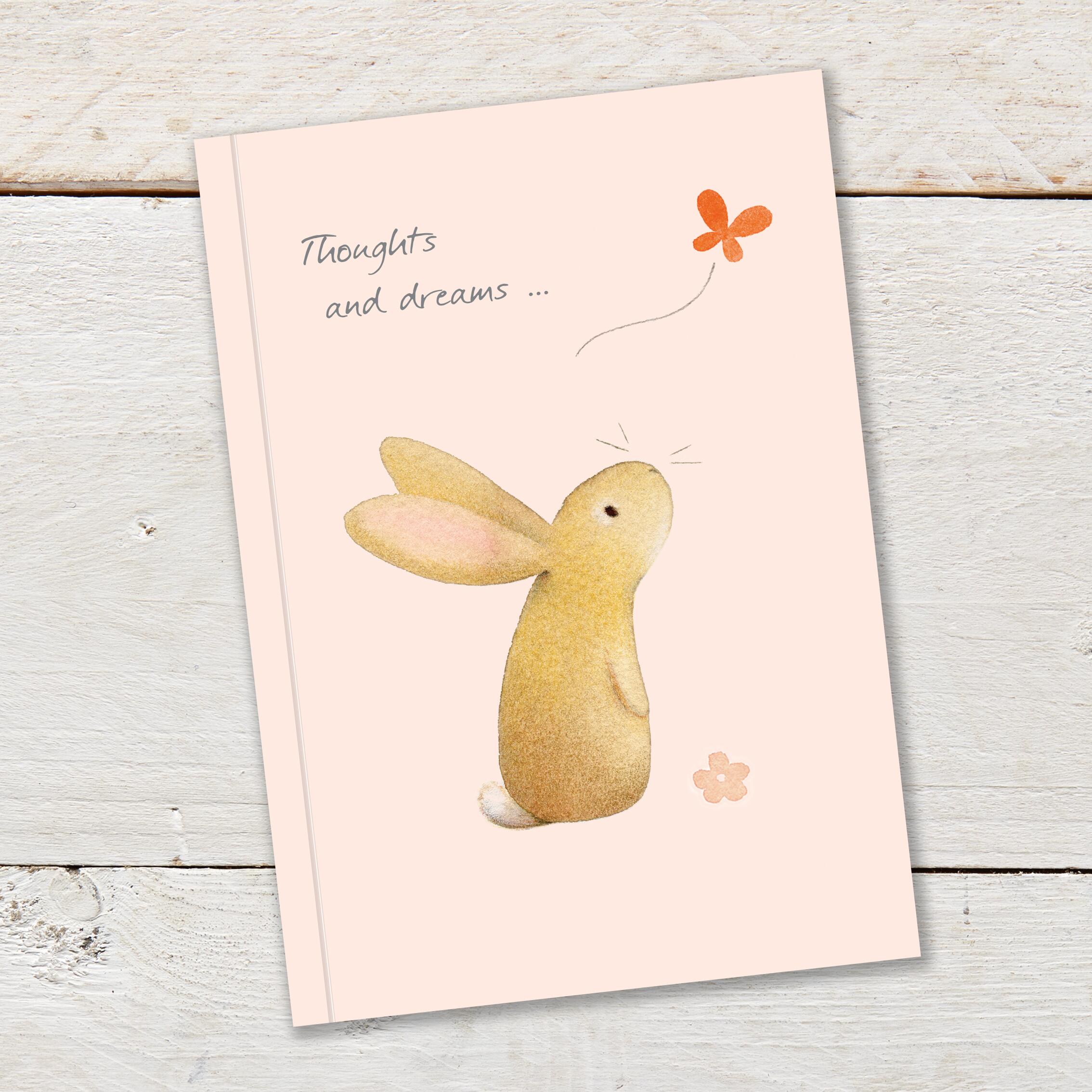 Notebook featuring a cute rabbit watching butterfly, on a pale peach background colour.