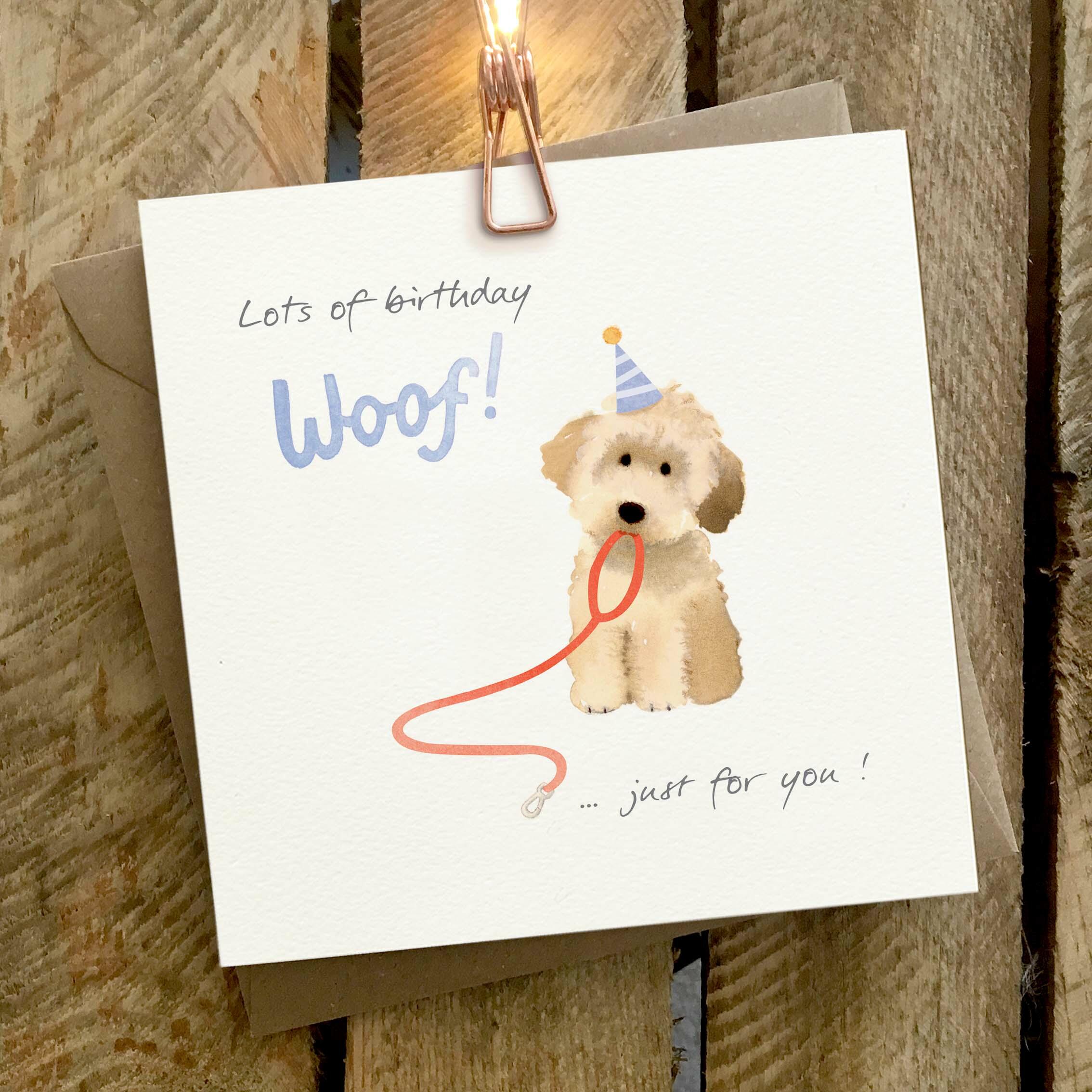 Card featuring a beige doodle dog with a lead in his mouth. Caption reads ‘Lots of Birthday Woof, Just for you”.
