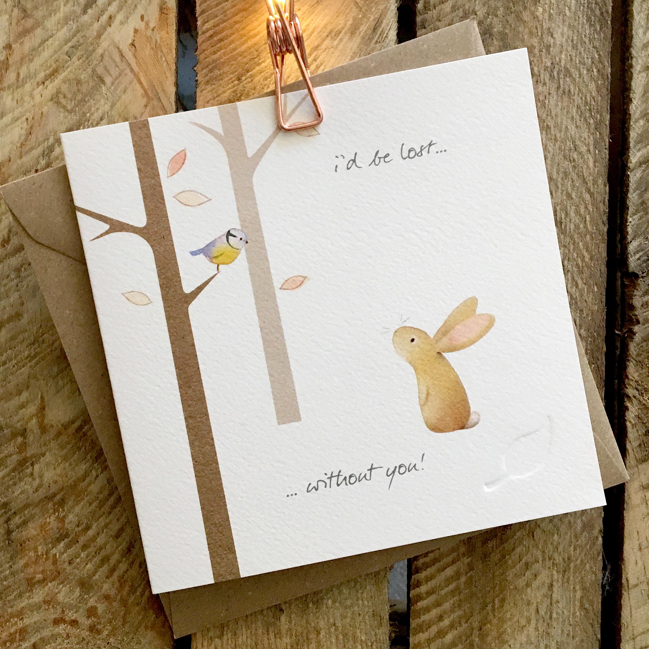 Card featuring a cute rabbit, thoughtfully looking at a blue tit perched in a woodland tree