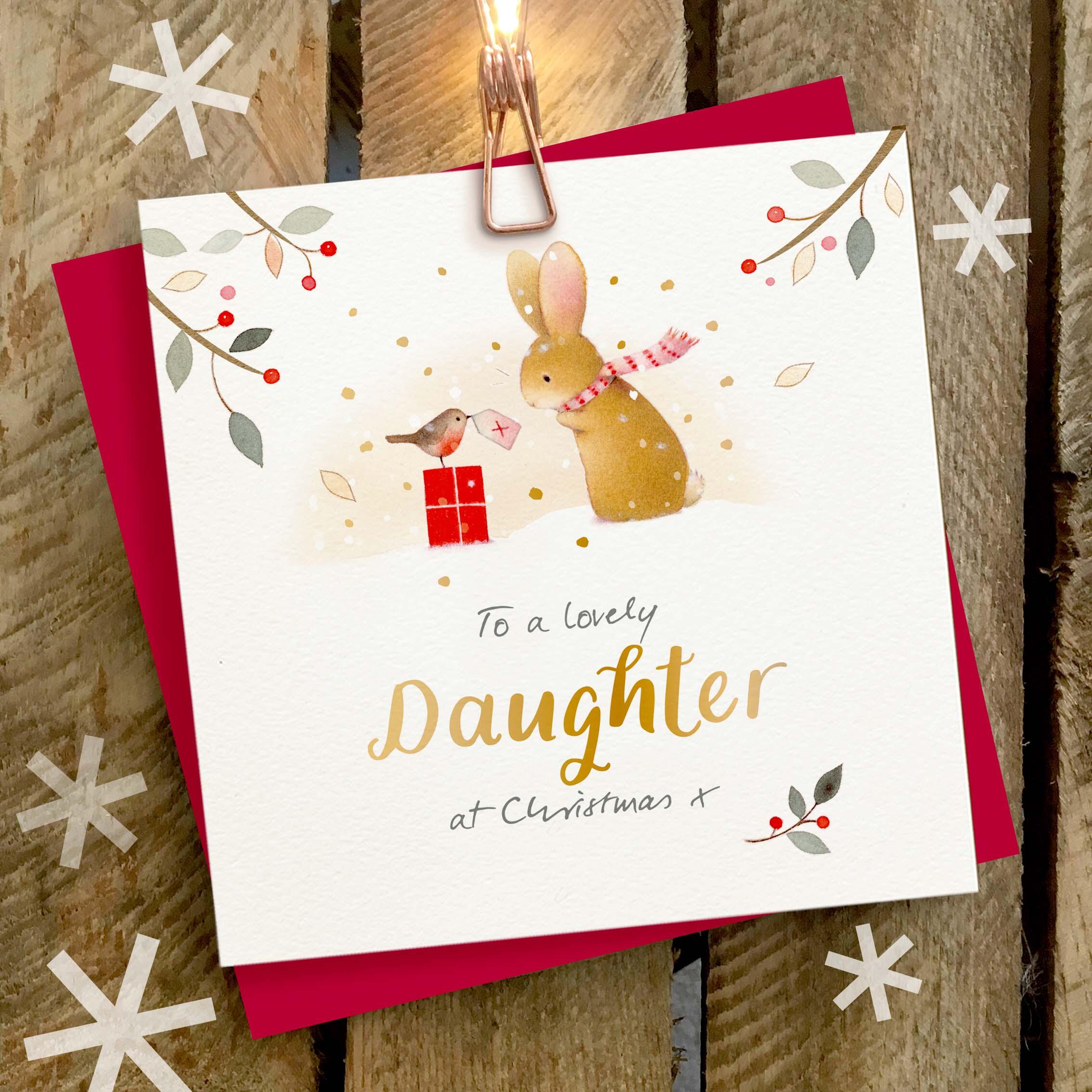 Christmas card featuring a large gold foil ‘Daughter’ caption with a cute rabbit and robin sat on a Christmas present.