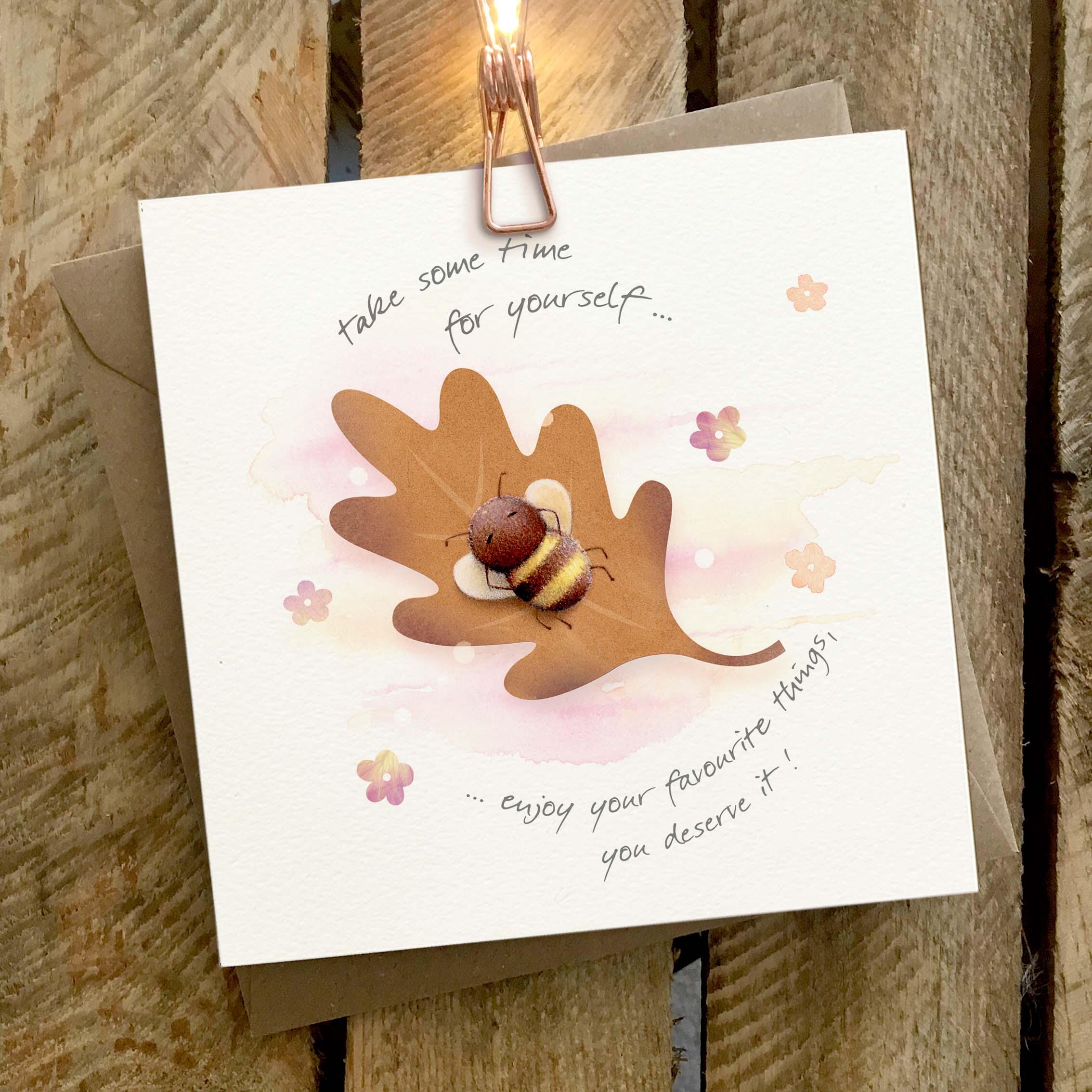 Greetings card featuring a bumble bee relaxing on a floating leaf.