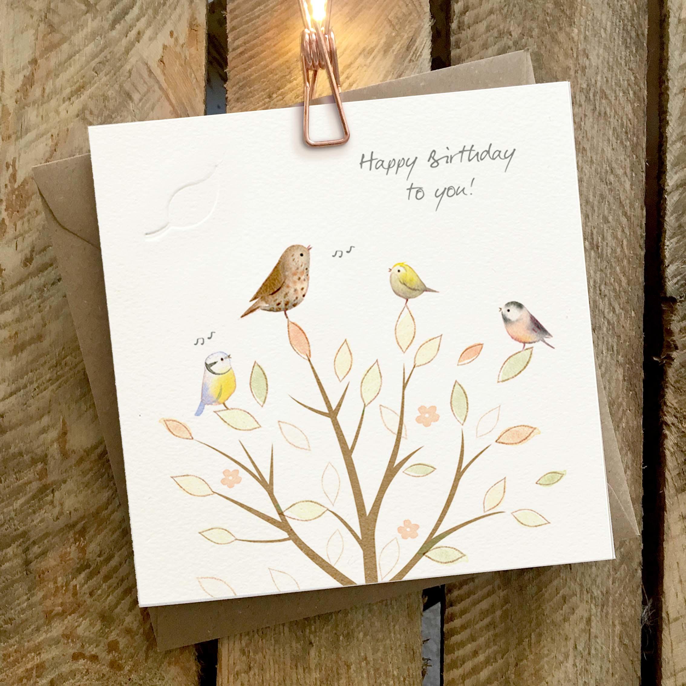 Card featuring cute birds sitting in a tree singing.