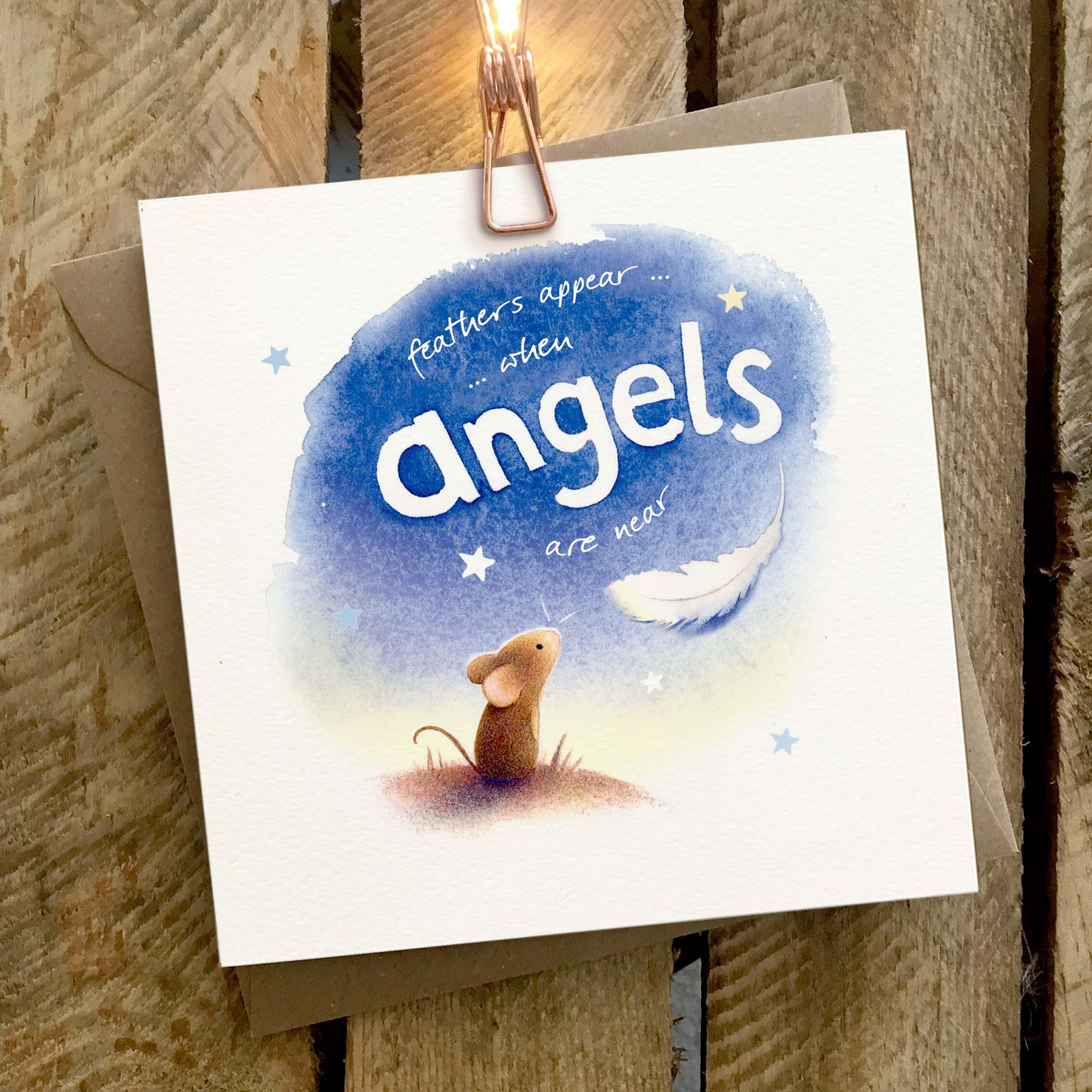 Greetings card featuring a mouse on a moonlit hill with a floating white feather.