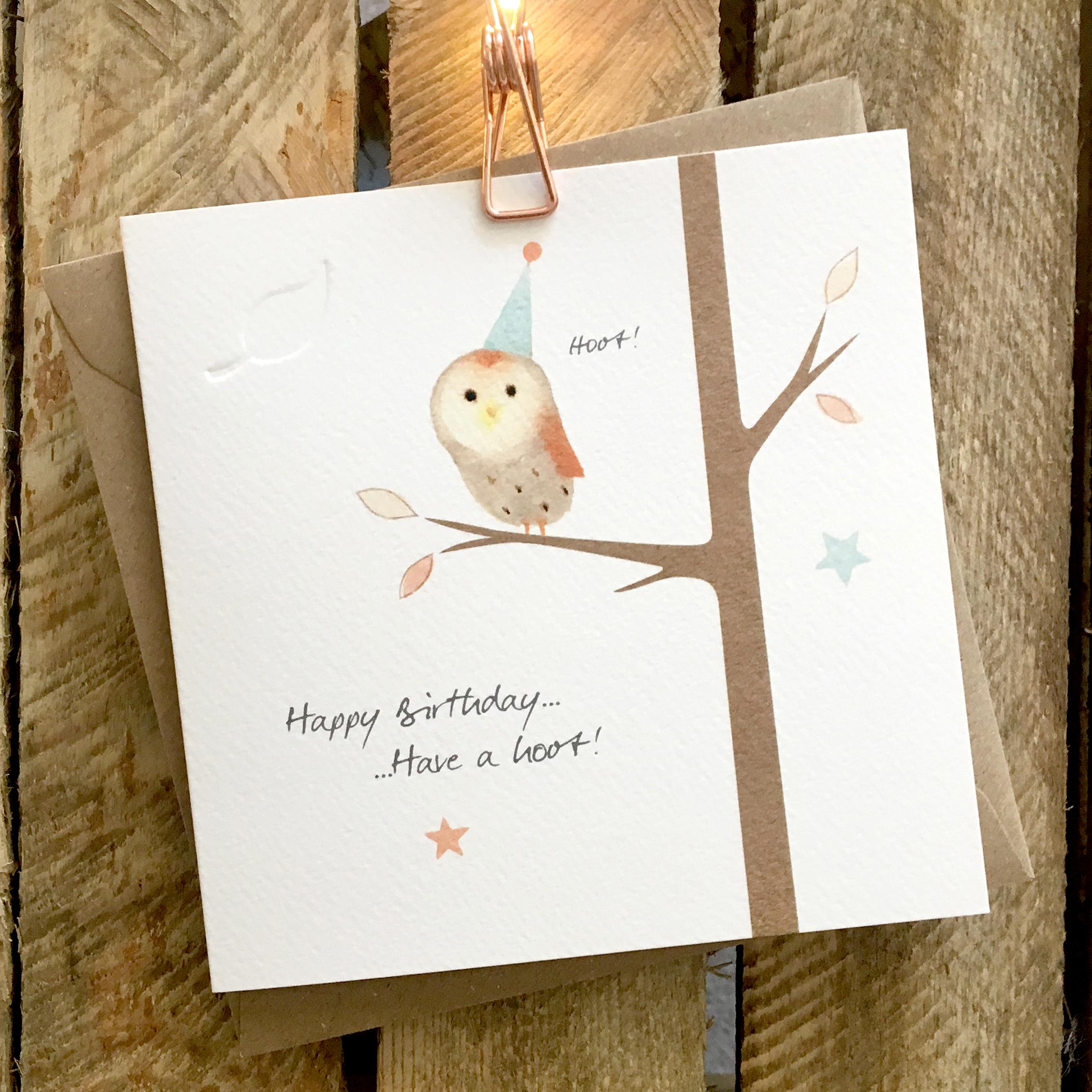 Card featuring a cute barn owl sat on a tree branch wearing a party hat