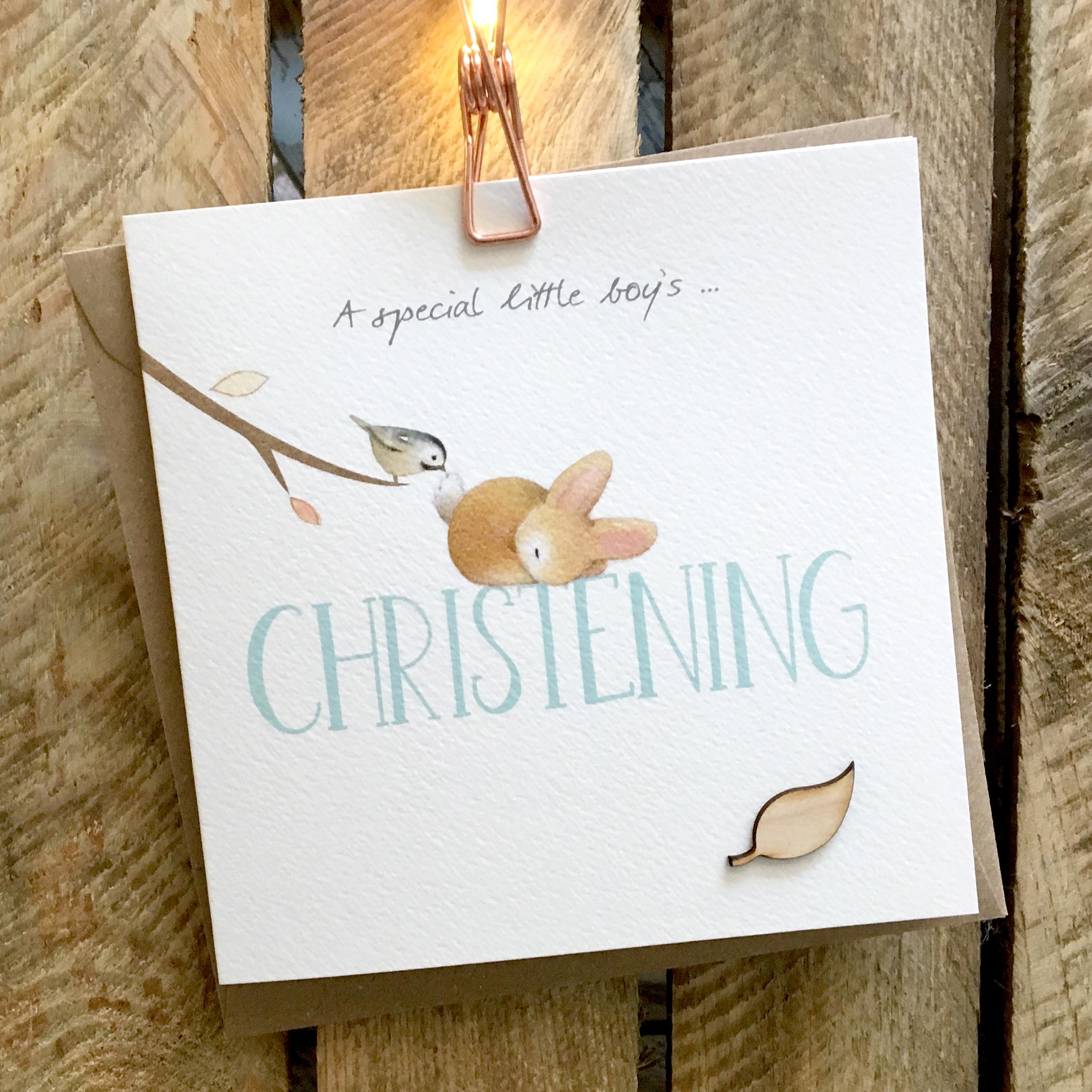 Card featuring a fluffy baby rabbit and small bird on top of a large blue CHRISTENING caption