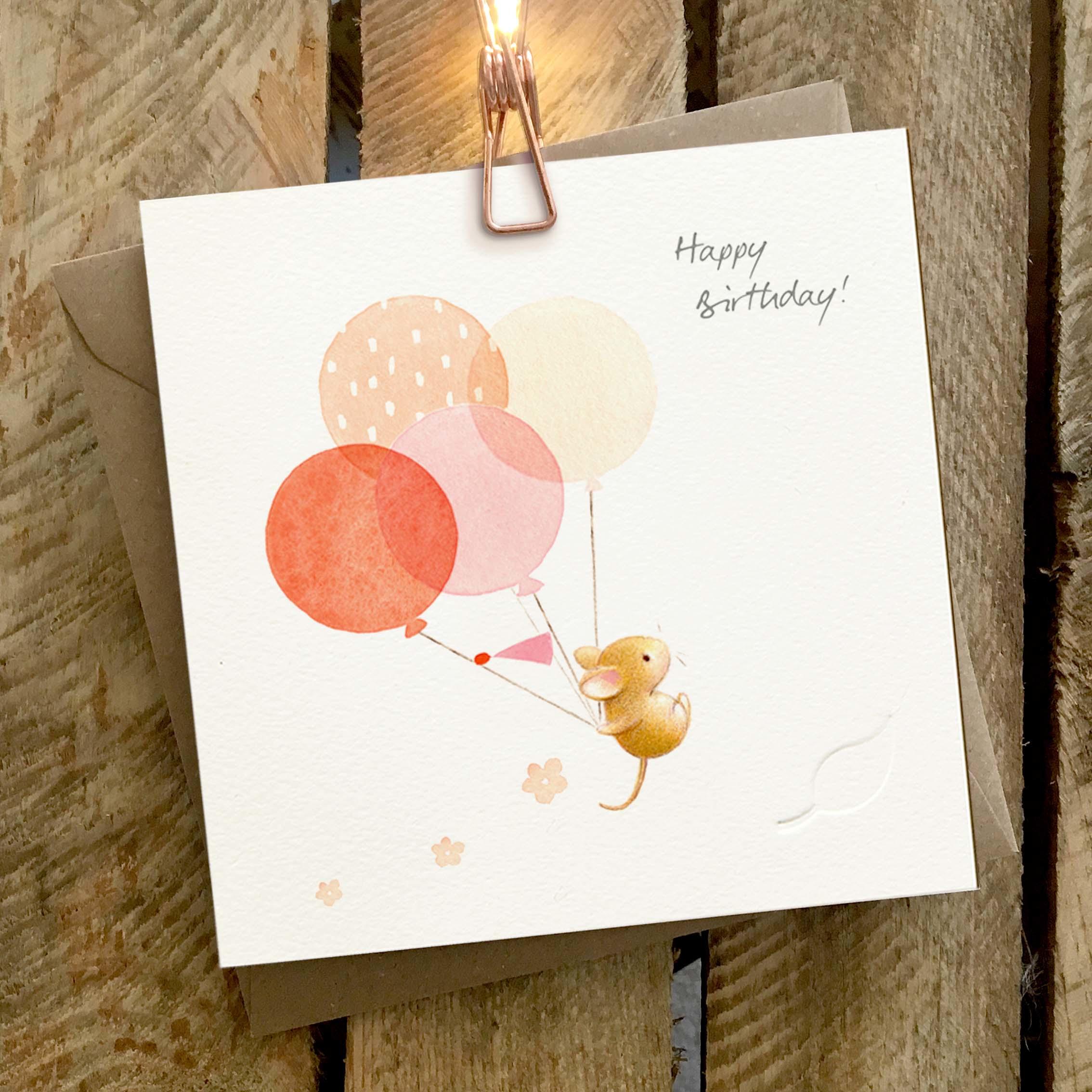 Card featuring a cute mouse holding onto a bunch of floating balloons.