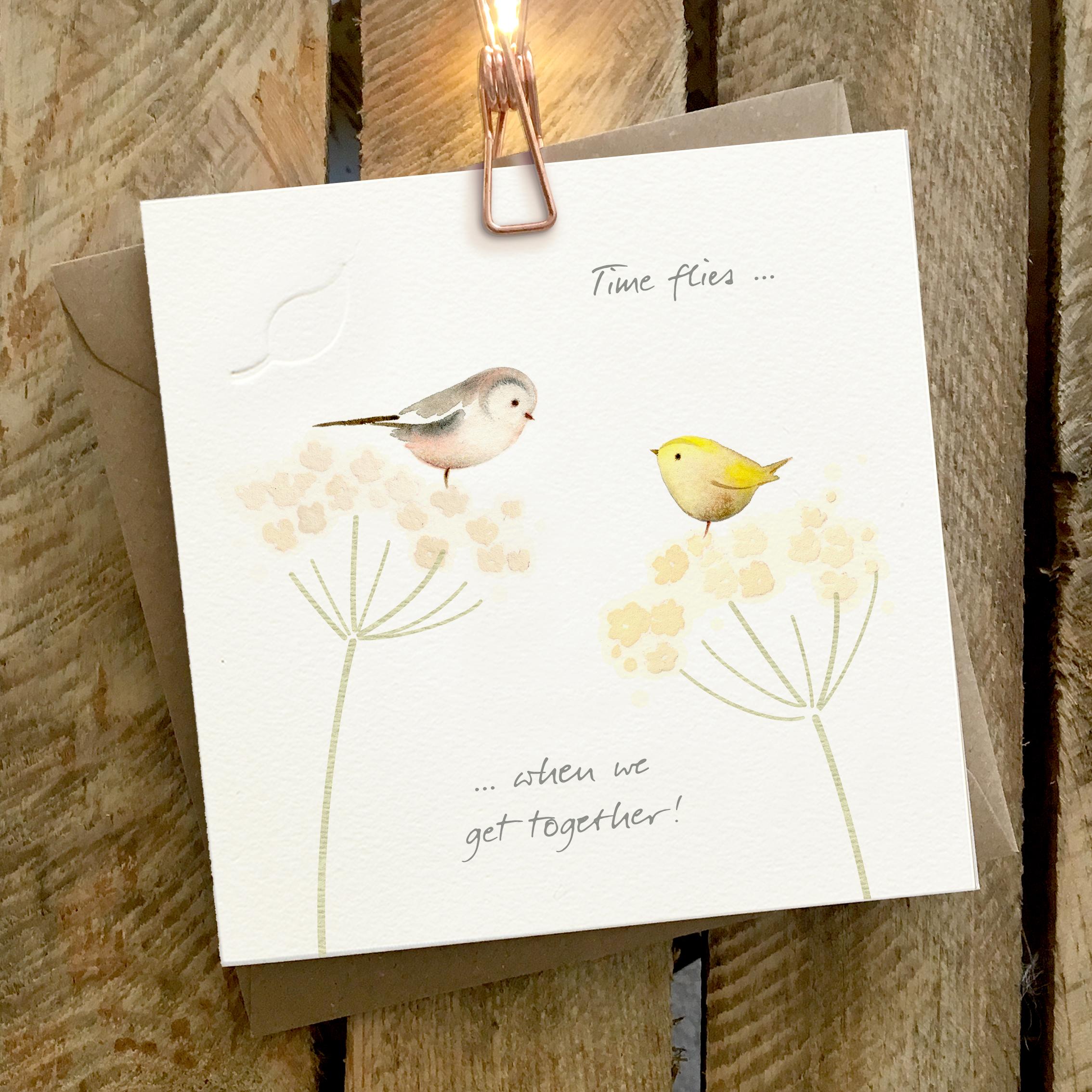 Card featuring two cute little birds sat on top of cow parsley. Caption reads “Time Flies… when we get together”
