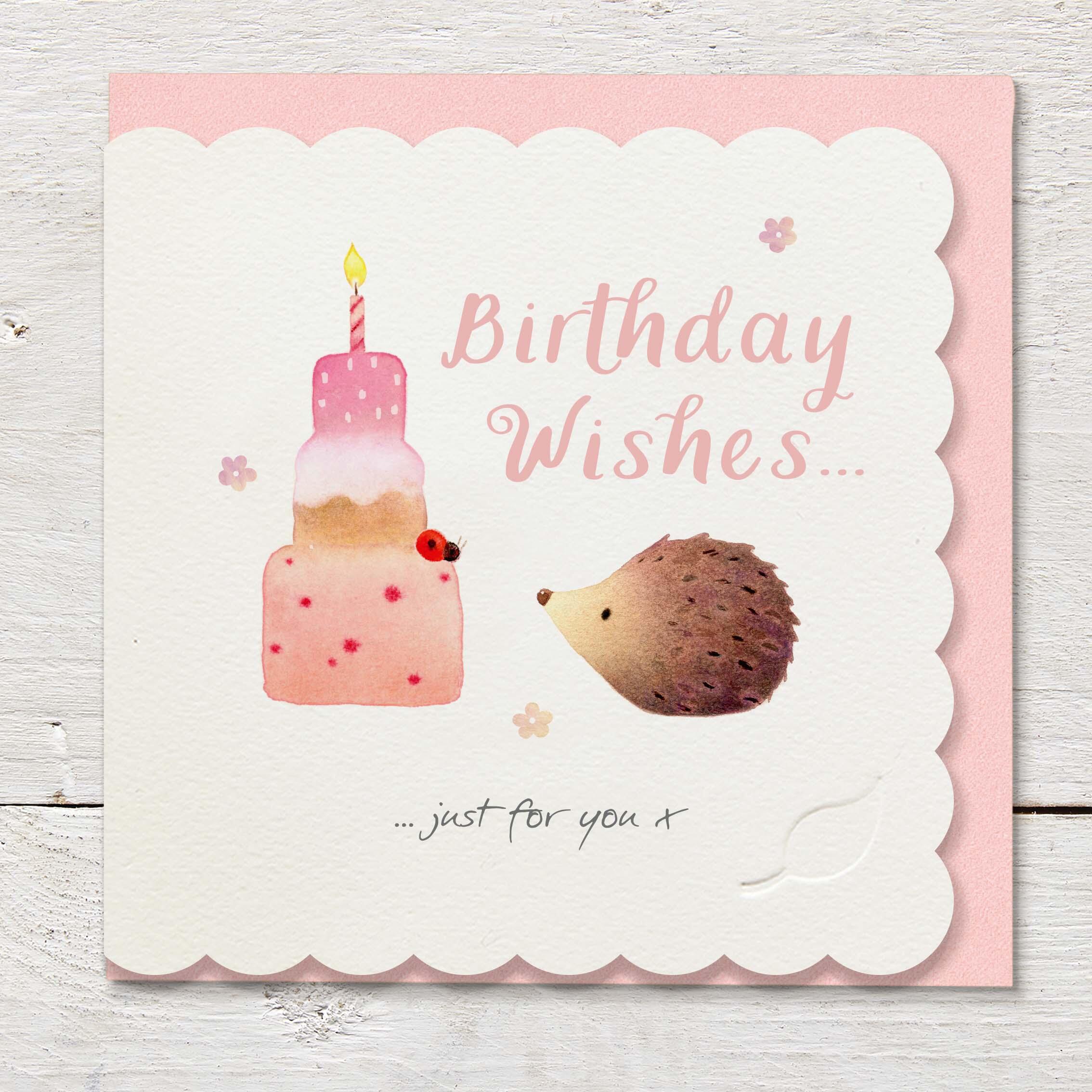 Die cut cardfeaturing a cute hedgehog with a large birthday cake.