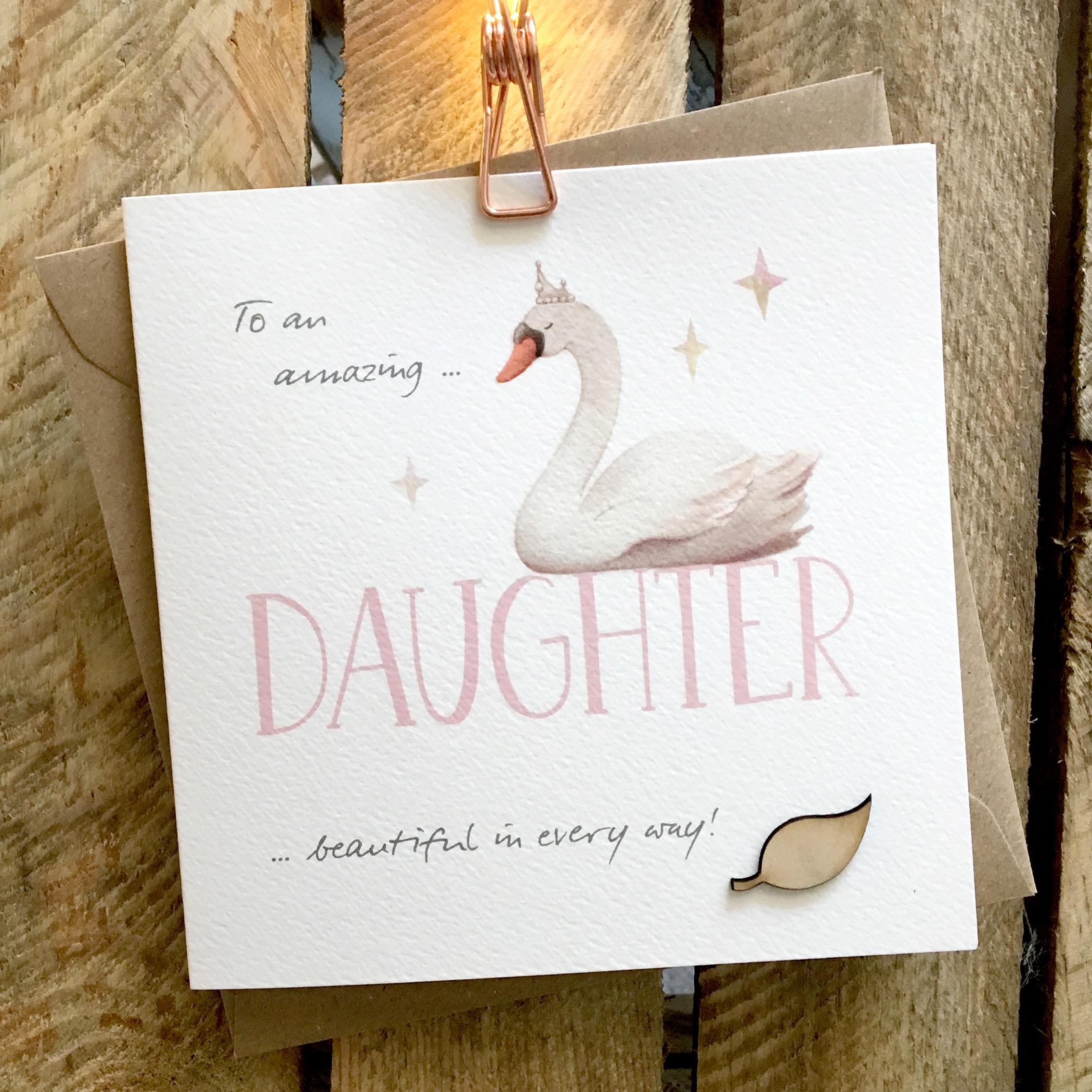Card featuring a majestic and beautiful swan, wearing a tiara, and sitting on top of a large DAUGHTER caption