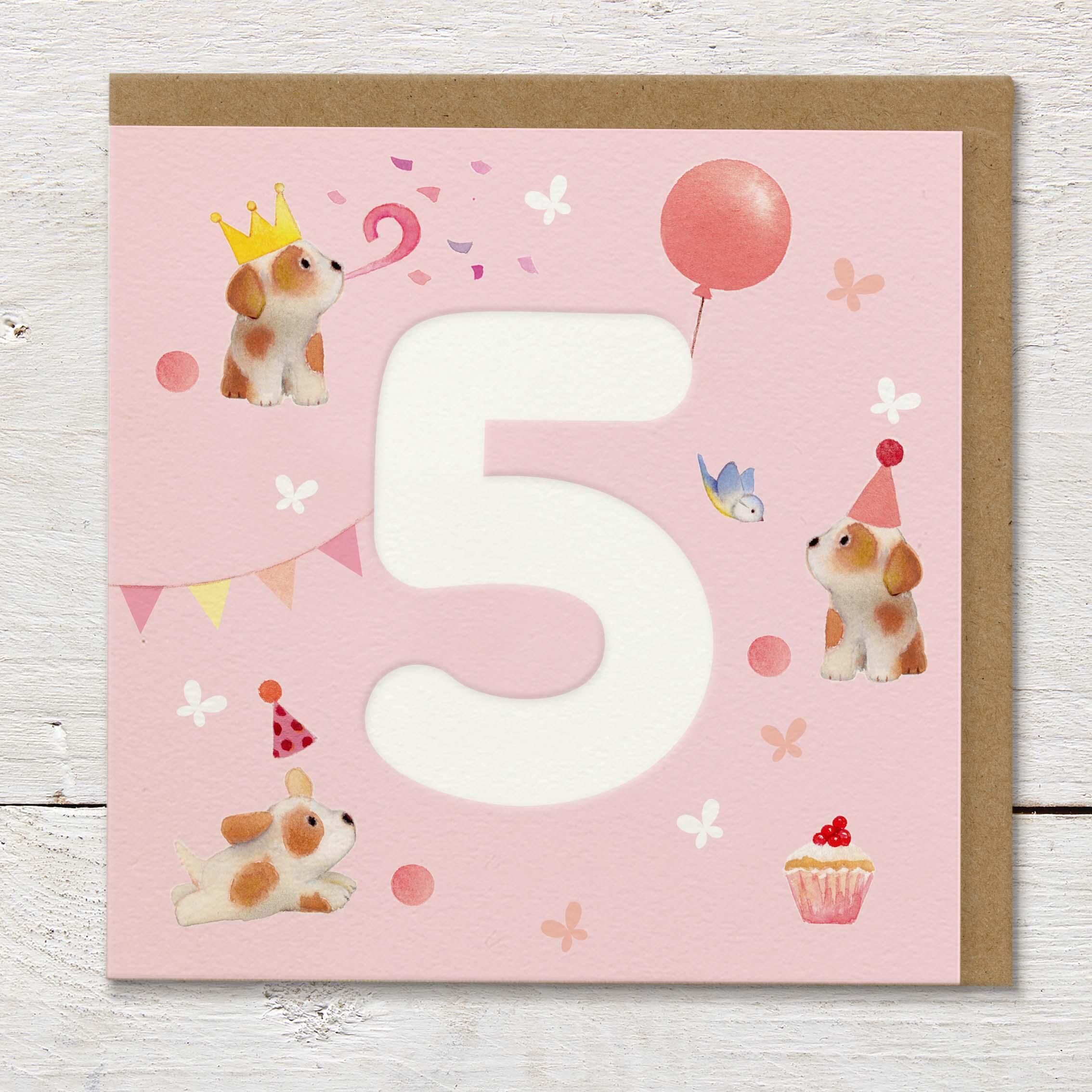 Children's age card featuring a large debossed age 5 surrounded by cute puppies and party elements on a pale pink background.