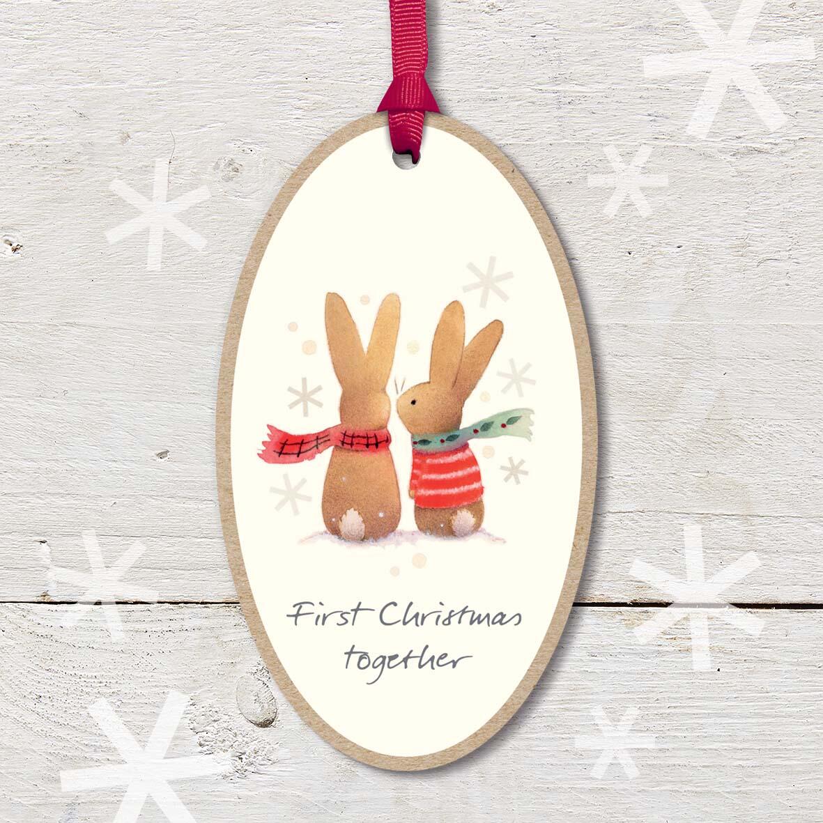 Large Christmas Wooden Plaque with attached red ribbon, featuring a cute rabbit couple, with a ’First Christmas Together’ caption.