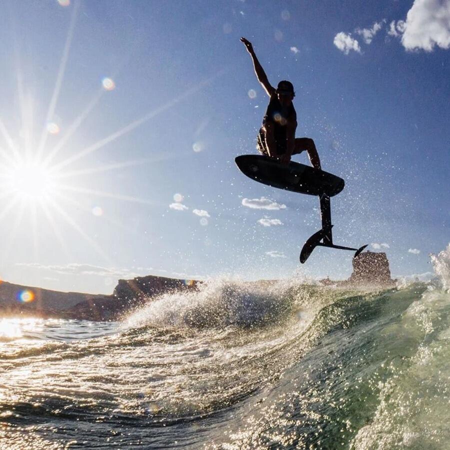 2 guys surf foiling on a lake