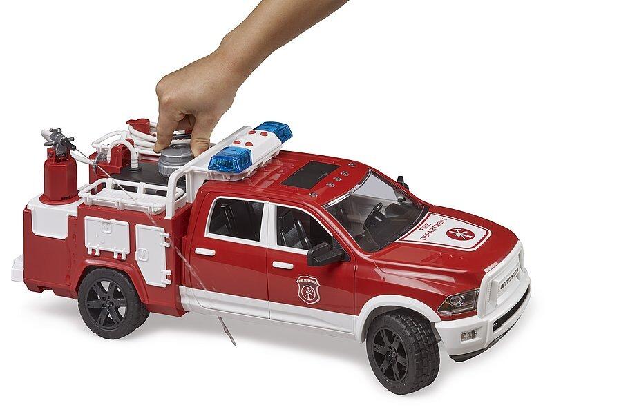 Child adjusting the top-mounted fire hose on the red RAM pickup fire truck toy