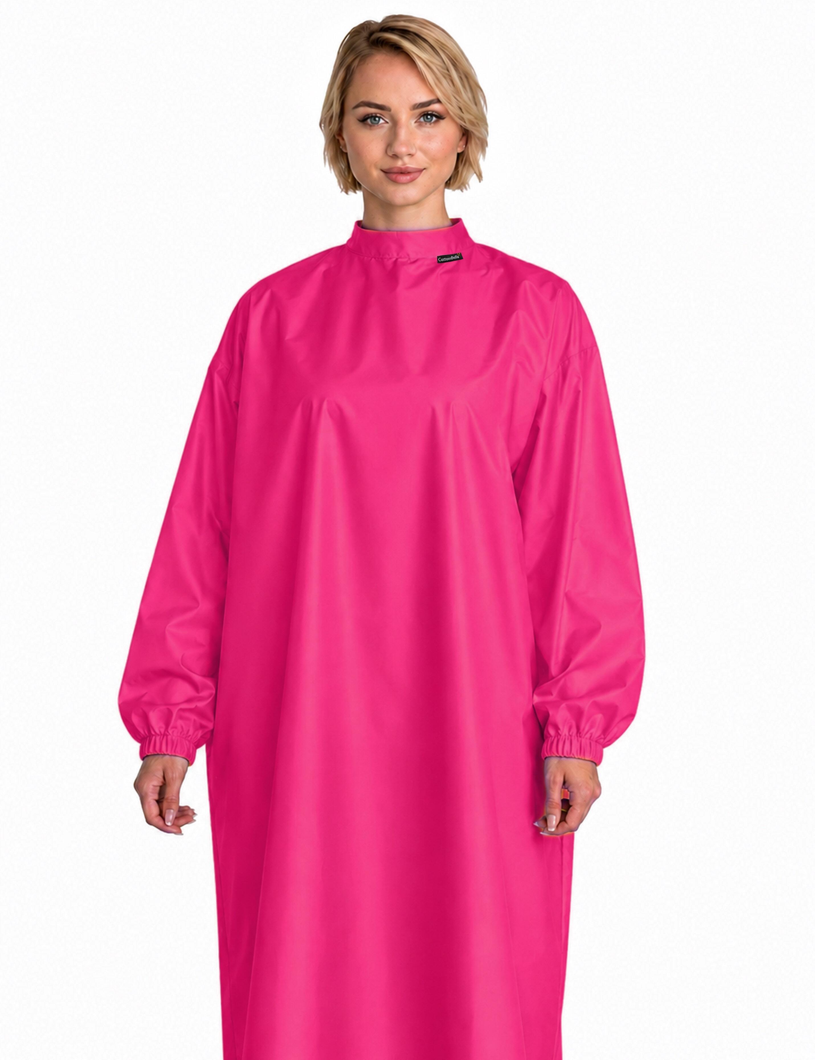 Bright hot pink salon styling cape featuring built-in sleeves for total client mobility and phone use