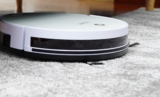 a robot vacuum cleaner sitting on a carpet