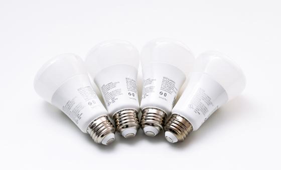 4 white smart bulbs on a white table