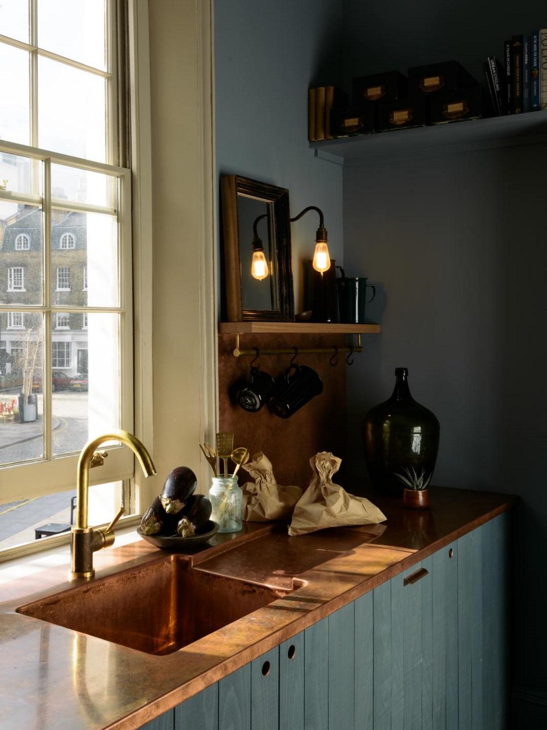 Dark deVOL kitchen with copper accents