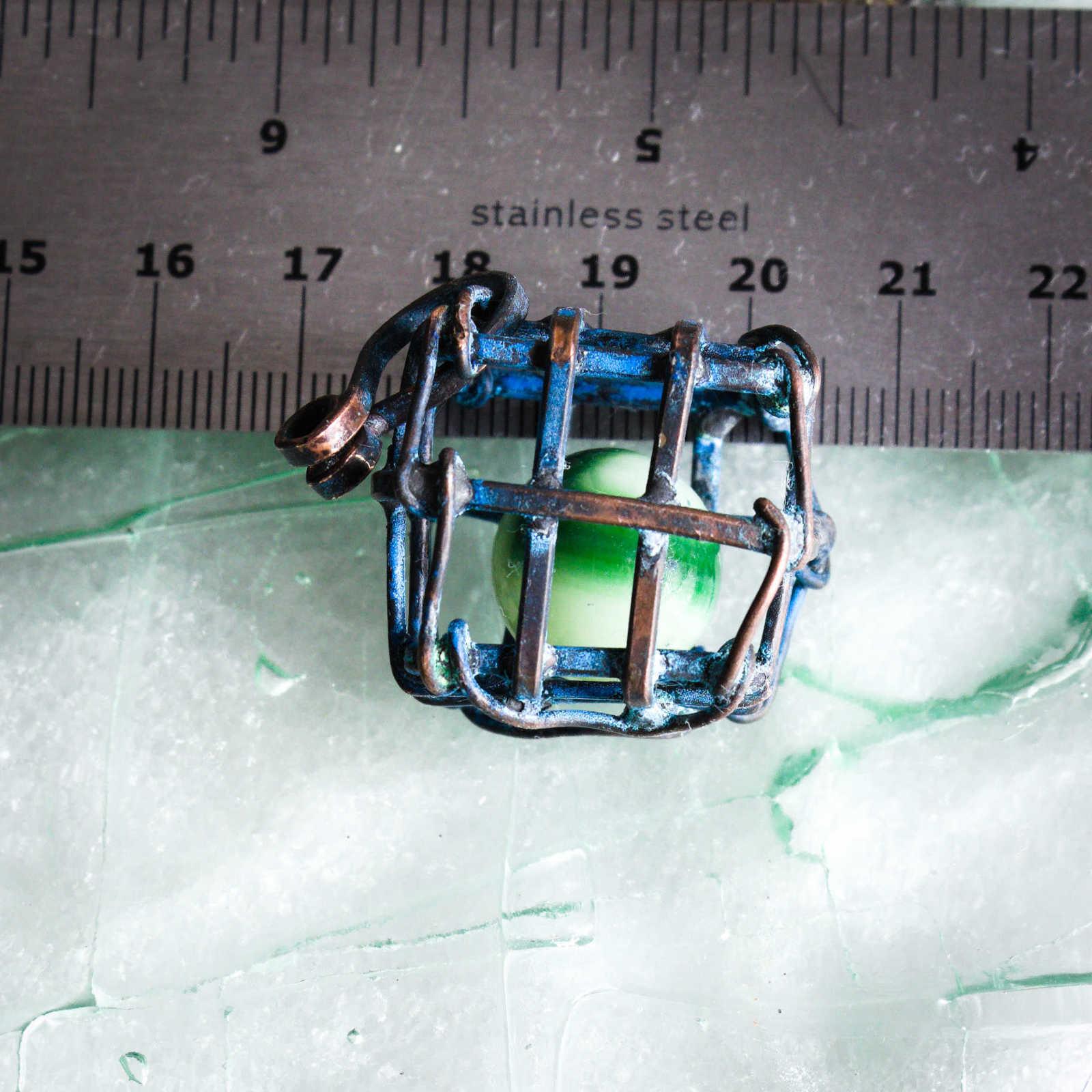 Captured in a Cage, Uranium Glass Marble with ruler to show scale