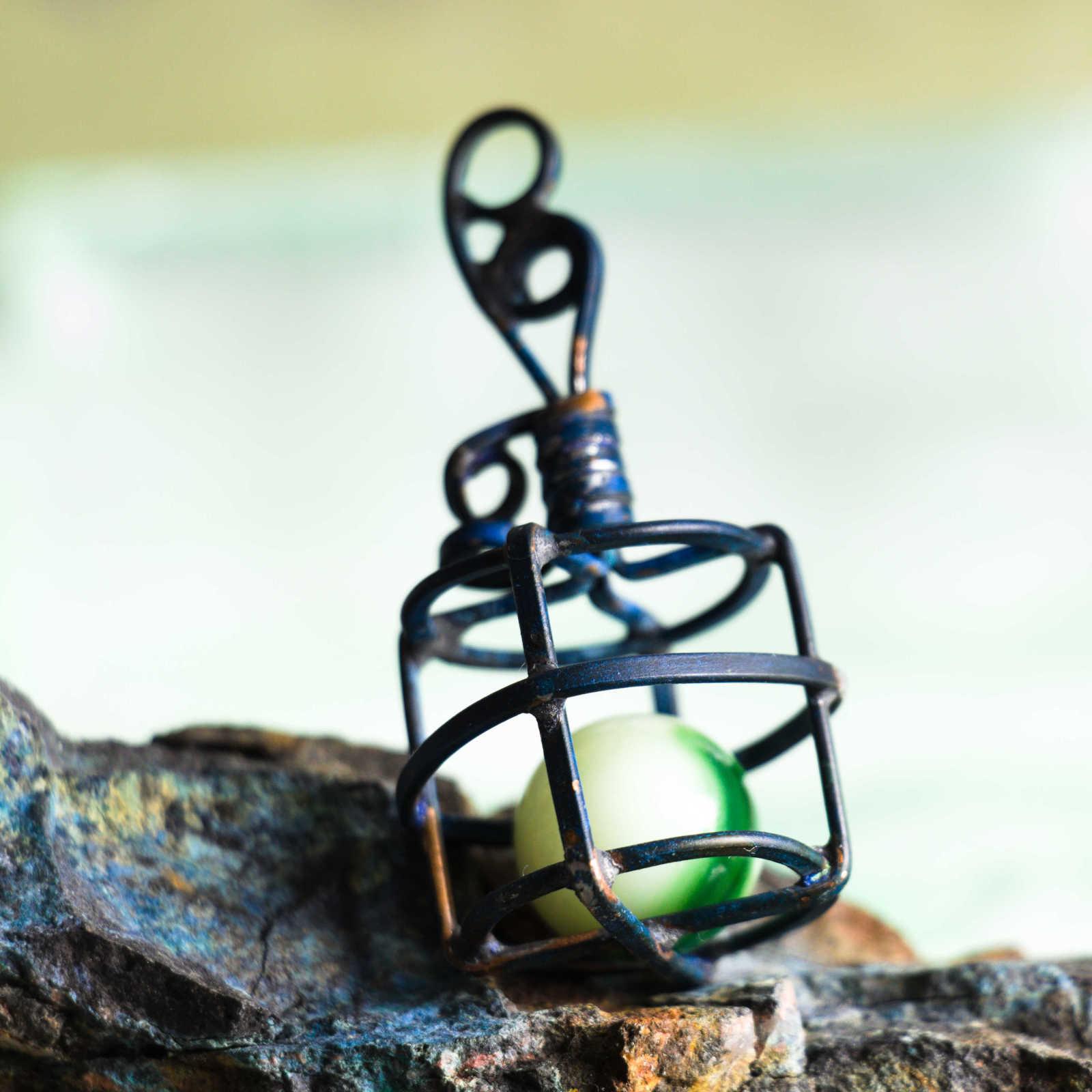Captured in a cage, Uranium glass marble
