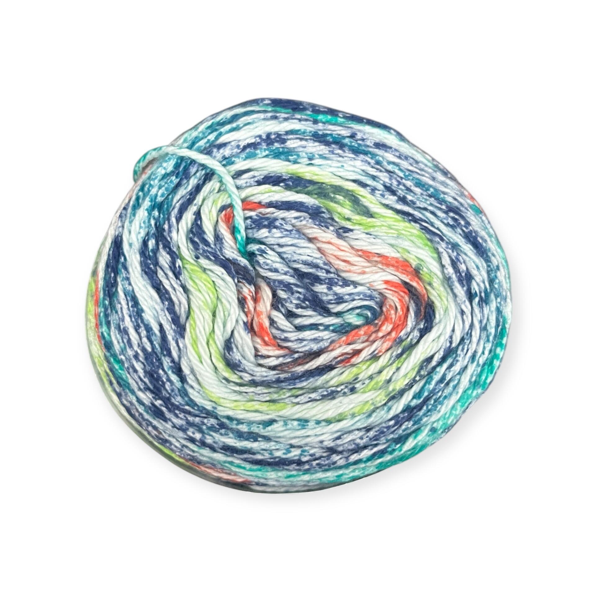James C. Brett Cotton Waves yarn cake in Hint of Autumn WV08 – 100% cotton DK yarn with blended tones of navy blue, green, orange, and white