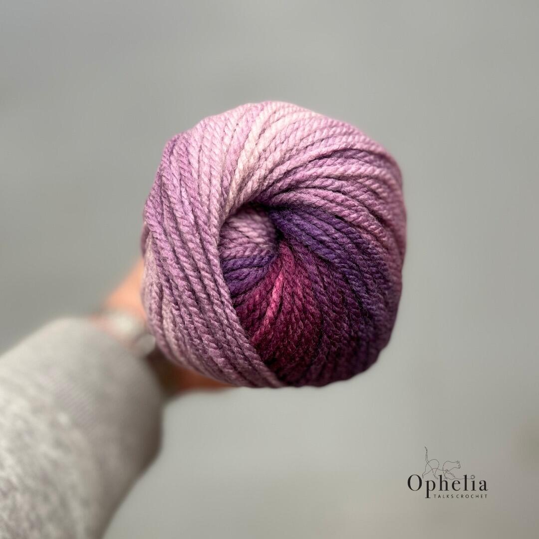 Top view of James C. Brett Aurora Chunky Mixed Berries AC08 highlighting smooth colour transitions from soft pink to rich plum and berry shades.