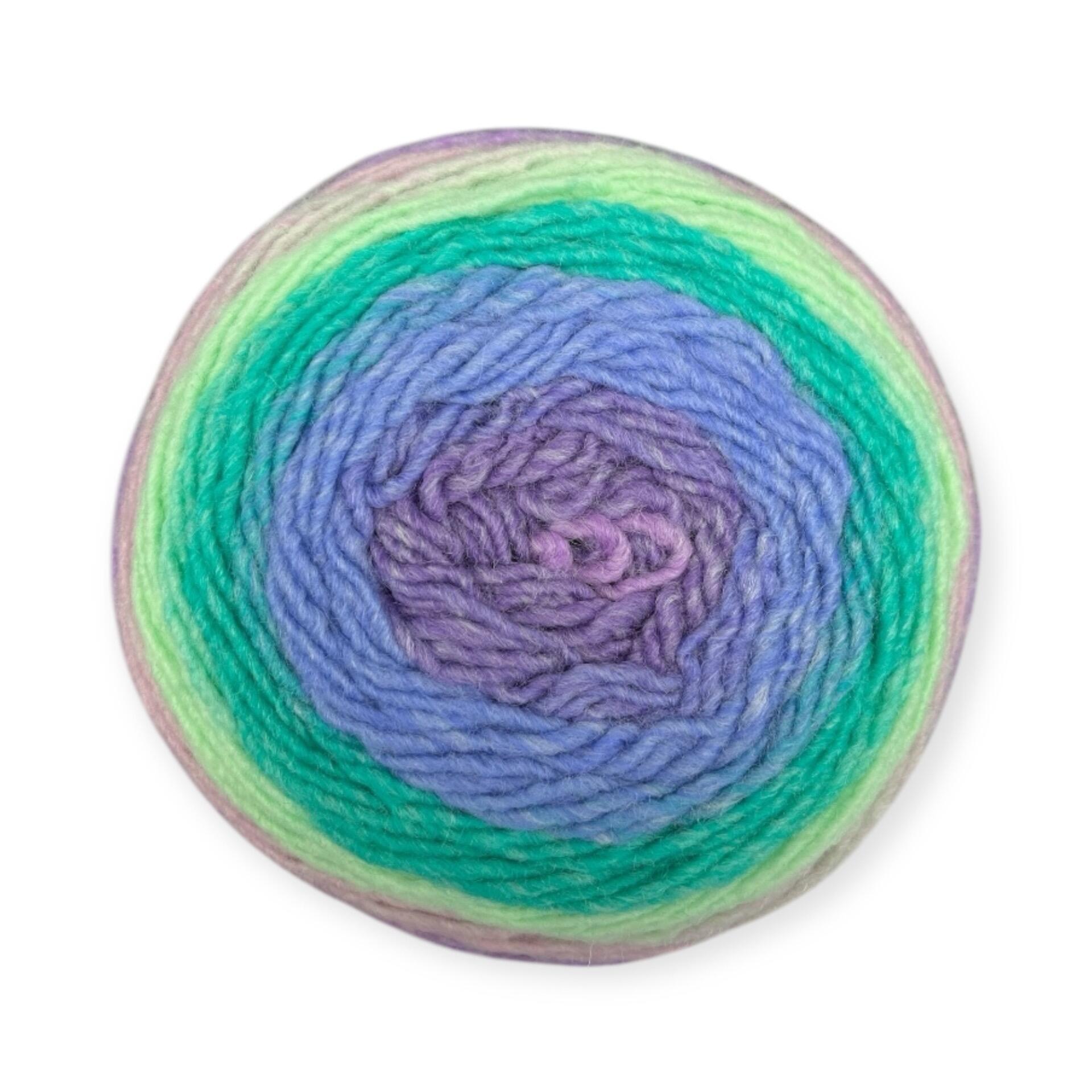 Gradient yarn cake of King Cole Curiosity DK in Victoria Plum (2905), featuring a blend of purple, lilac, and green tones—ideal for vibrant knitting and crochet projects.