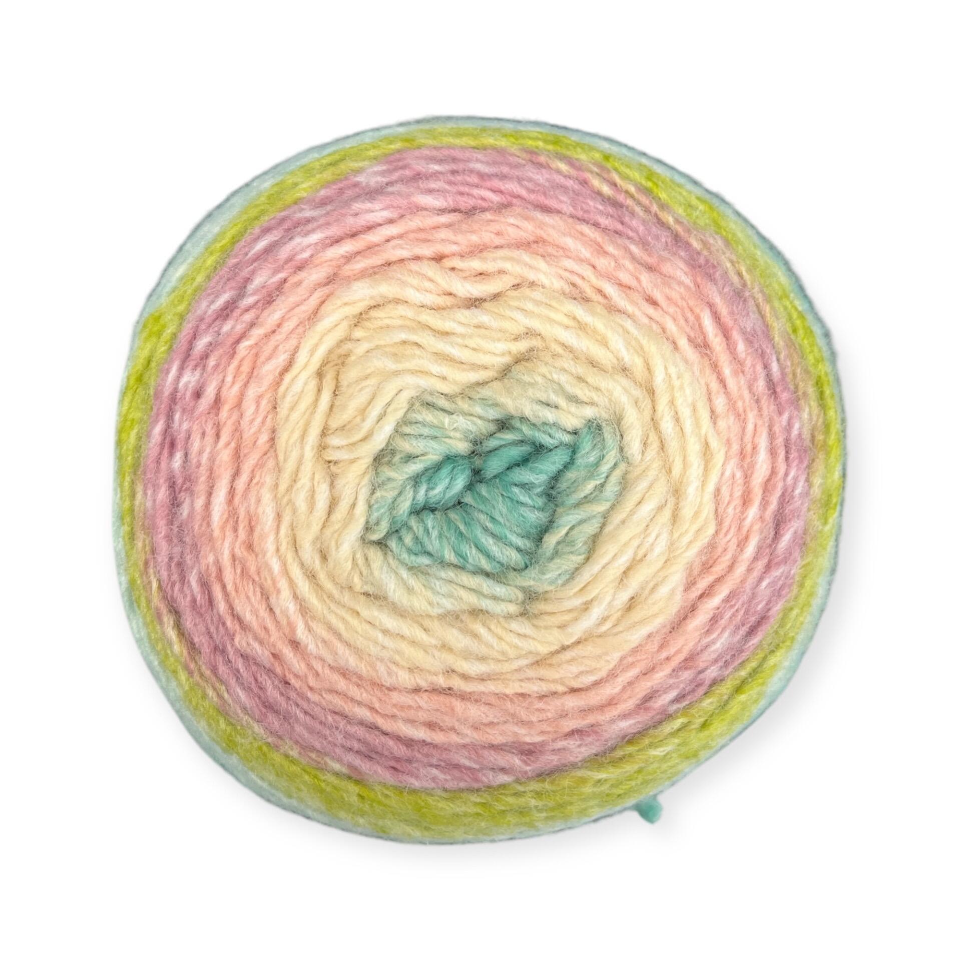 Gradient yarn cake of King Cole Curiosity DK in Summer Days (6330), showing soft mint green, cream, peach, and lime shades—ideal for summery knitting and crochet creations.