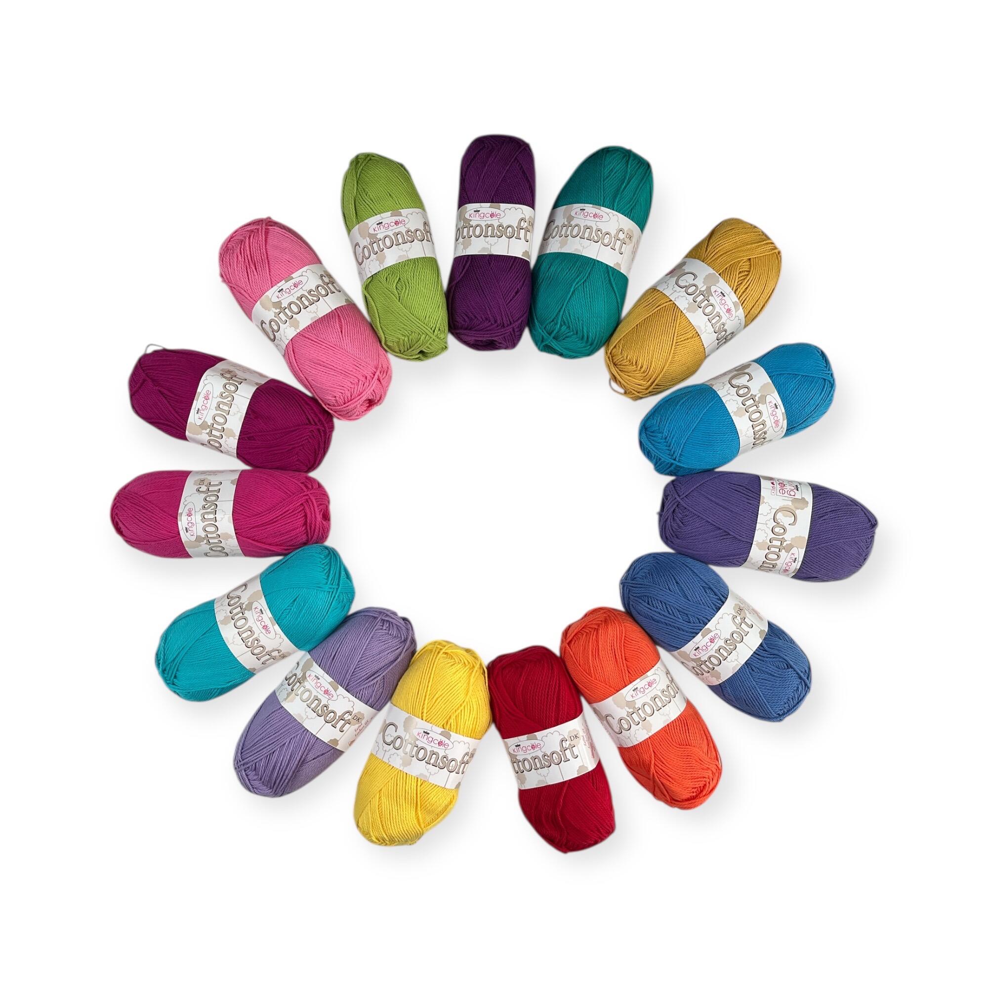 King Cole Cottonsoft yarn pack in 16 vibrant colours, beautifully arranged in a circle. Includes a mix of bold reds, blues, purples, greens, yellows, and pinks. Ideal for summer crochet projects with its soft and breathable cotton texture.