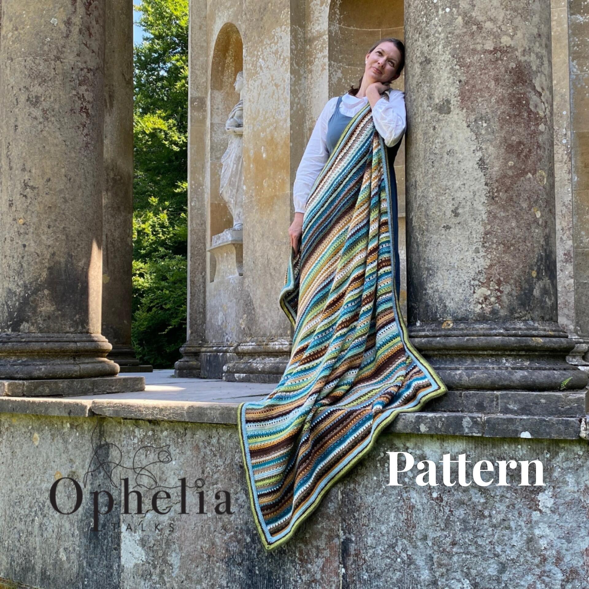 Lizzie blanket hold by Anja against a pillar at the Apollo saying pattern on the bottom right hand corner