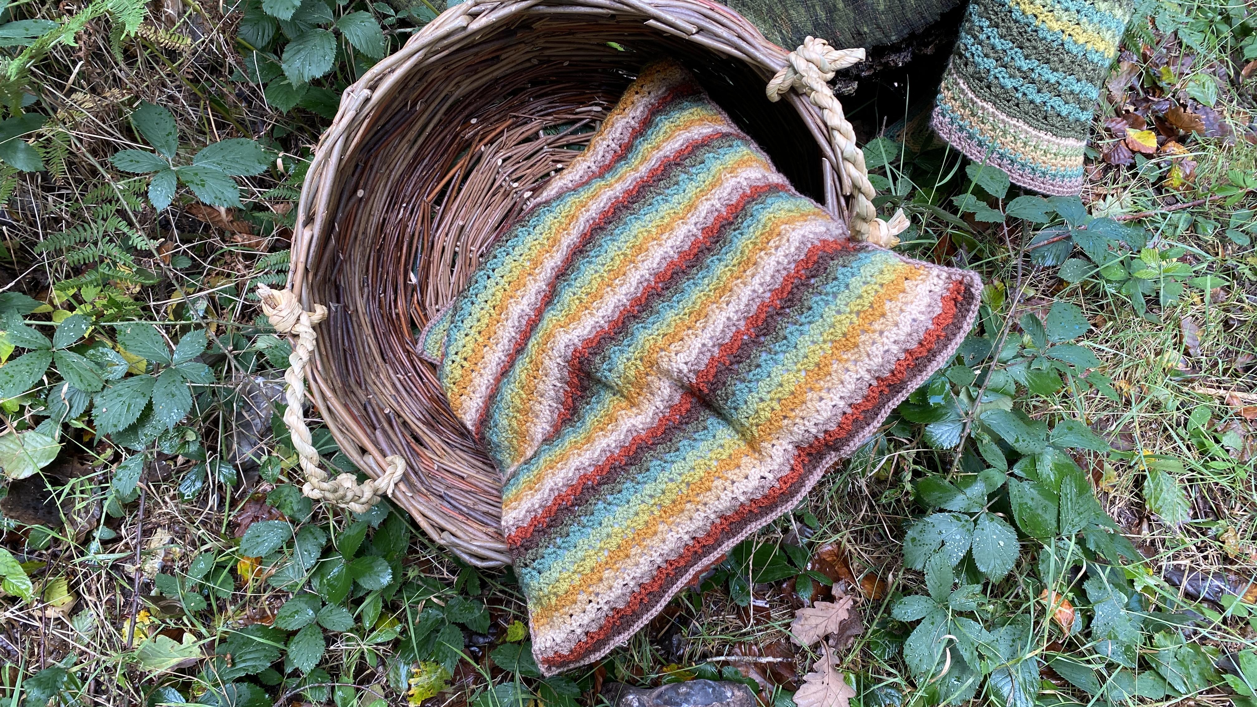 Autumn Walk cushion cover in basket in the woods