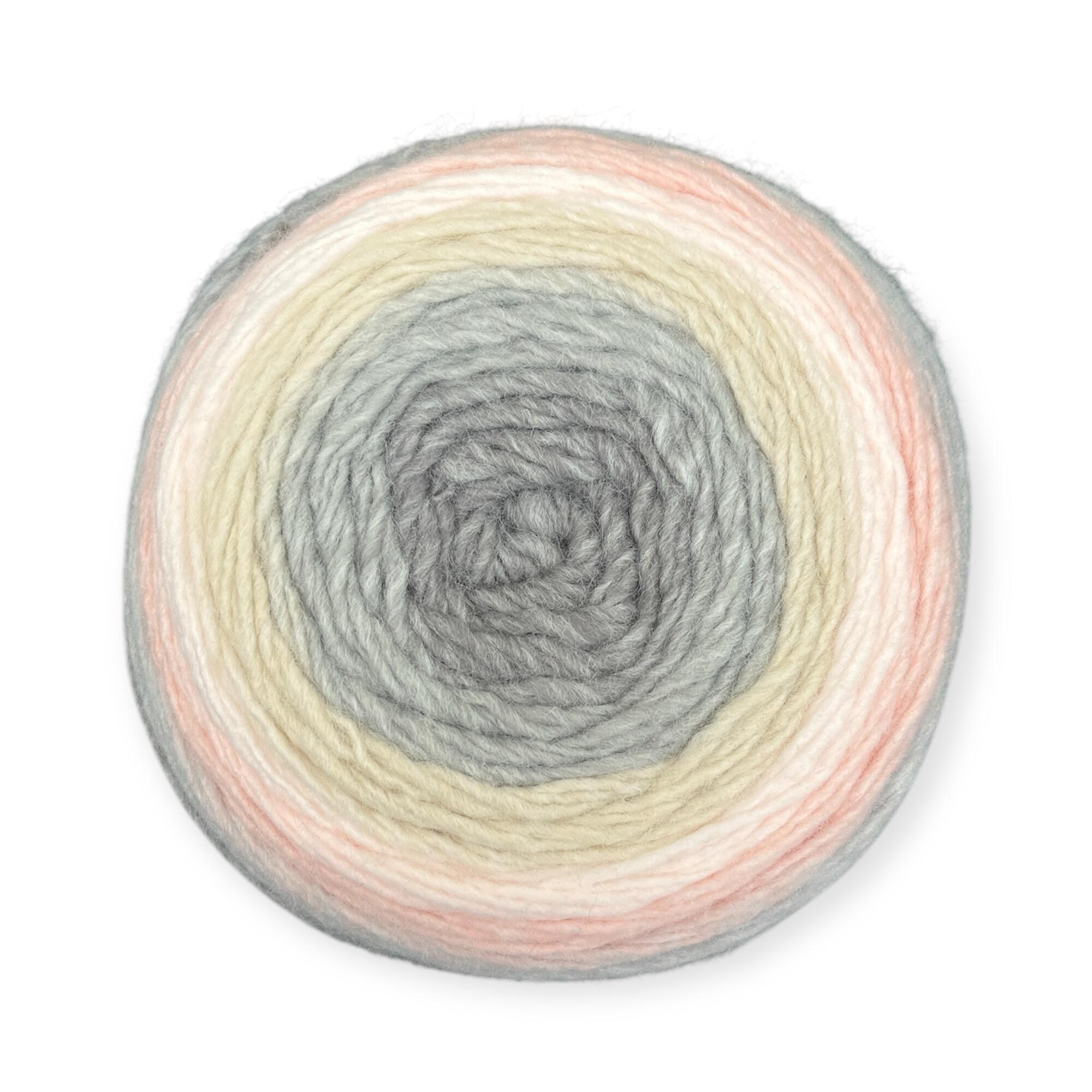 Gradient yarn cake of King Cole Curiosity DK in Mother of Pearl (2904), showcasing soft shades of gray, cream, and blush pink, ideal for knitting and crochet projects.