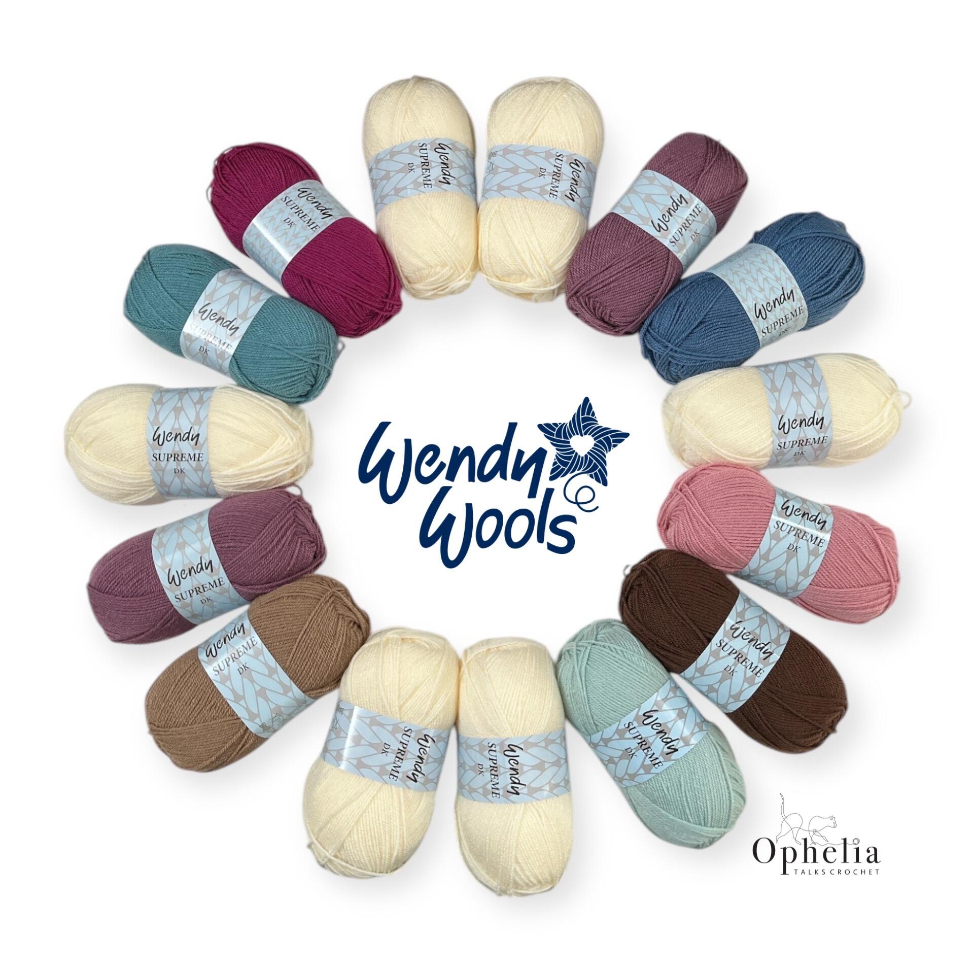 A yarn pack of 15 Wendy Supreme DK yarn balls arranged neatly in a circular display, featuring a harmonious palette of cream, pink, teal, blue, and brown shades, specially selected for the Odyssey Crochet-Along by Ophelia Talks Crochet.