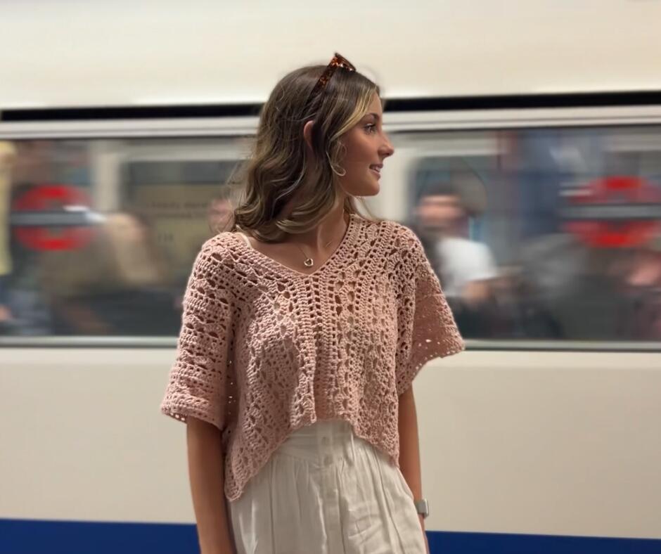 Young girl wearing the pixie bolero in a tube station with the train passing by in the background