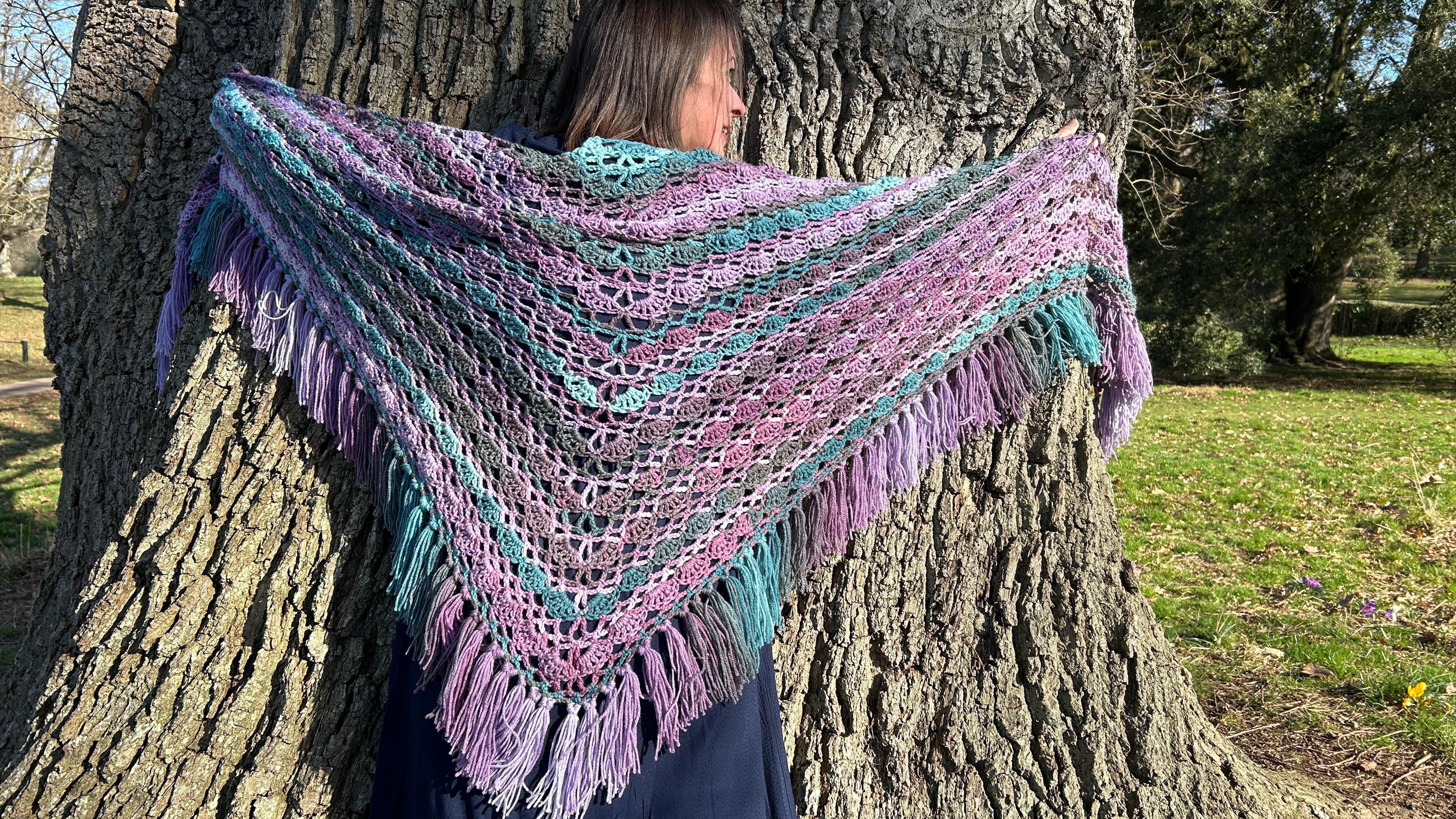 Snow moon shawl worn and standing against a tree