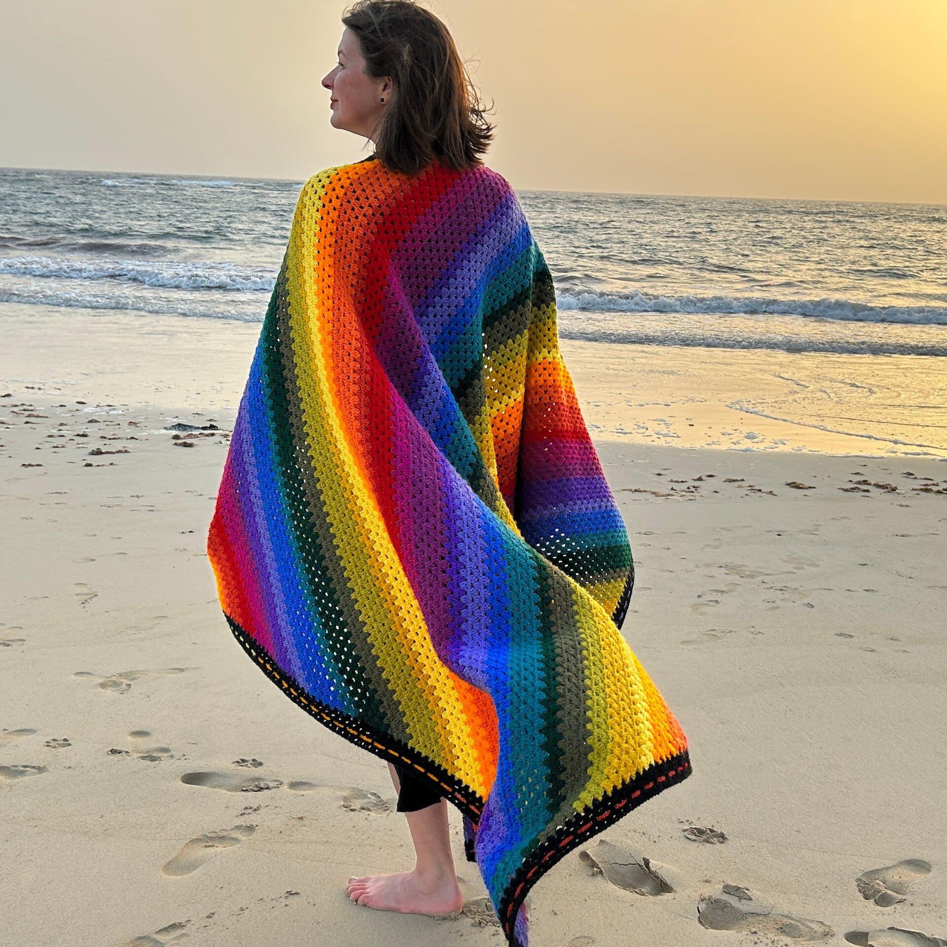 colour theory blanket worn on the shoulders on the beach at sunrise