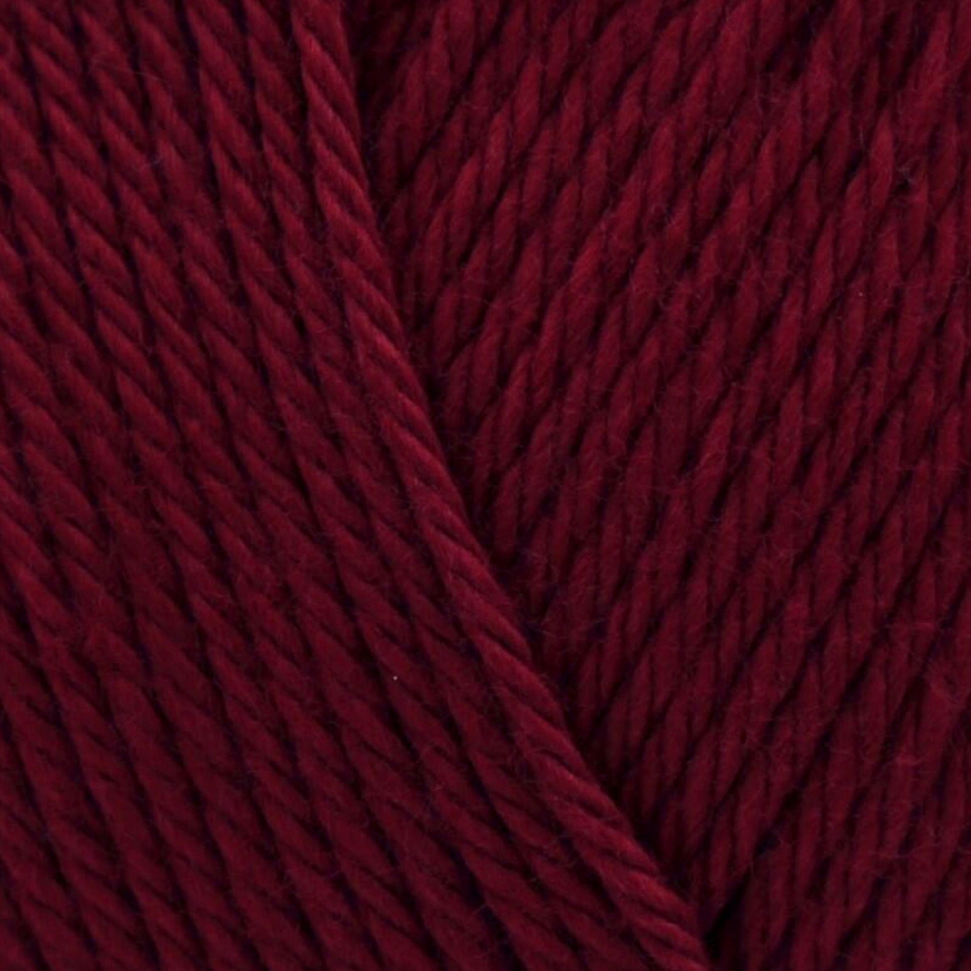 James C. Brett It’s Pure Cotton DK yarn Claret IC23, deep wine red 100% cotton DK yarn texture close-up.