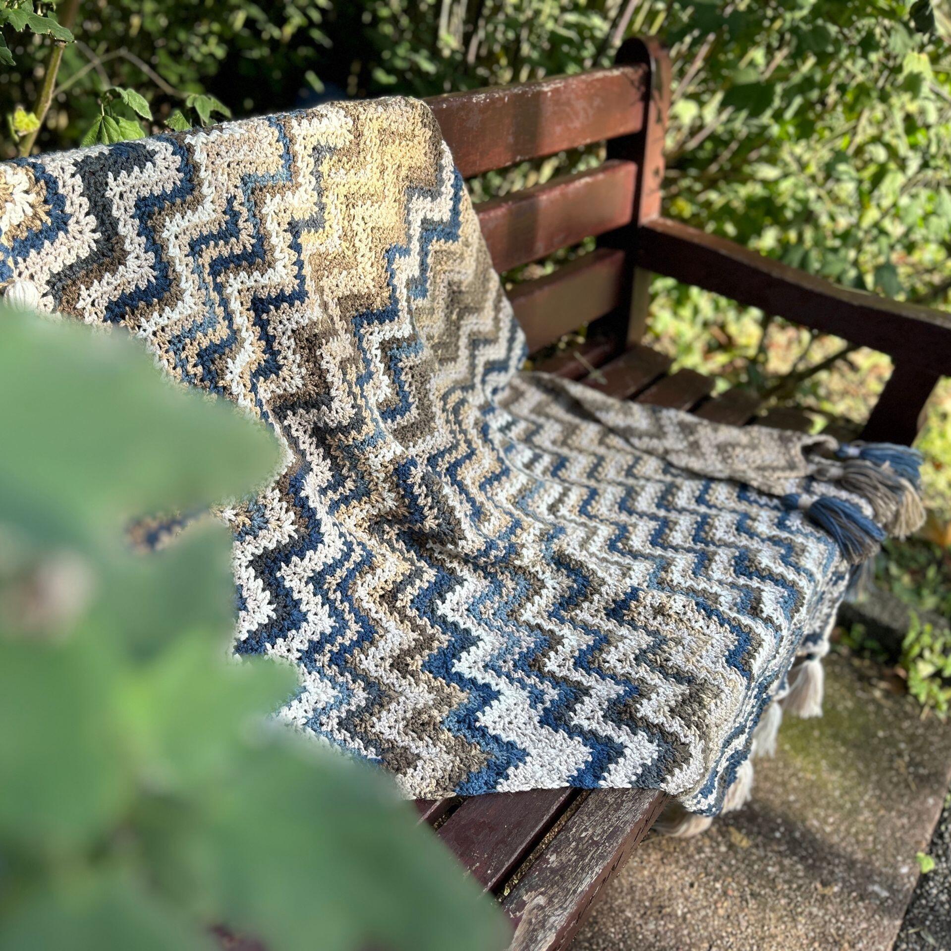 The winter solace blanket laid out on a bench in a park
