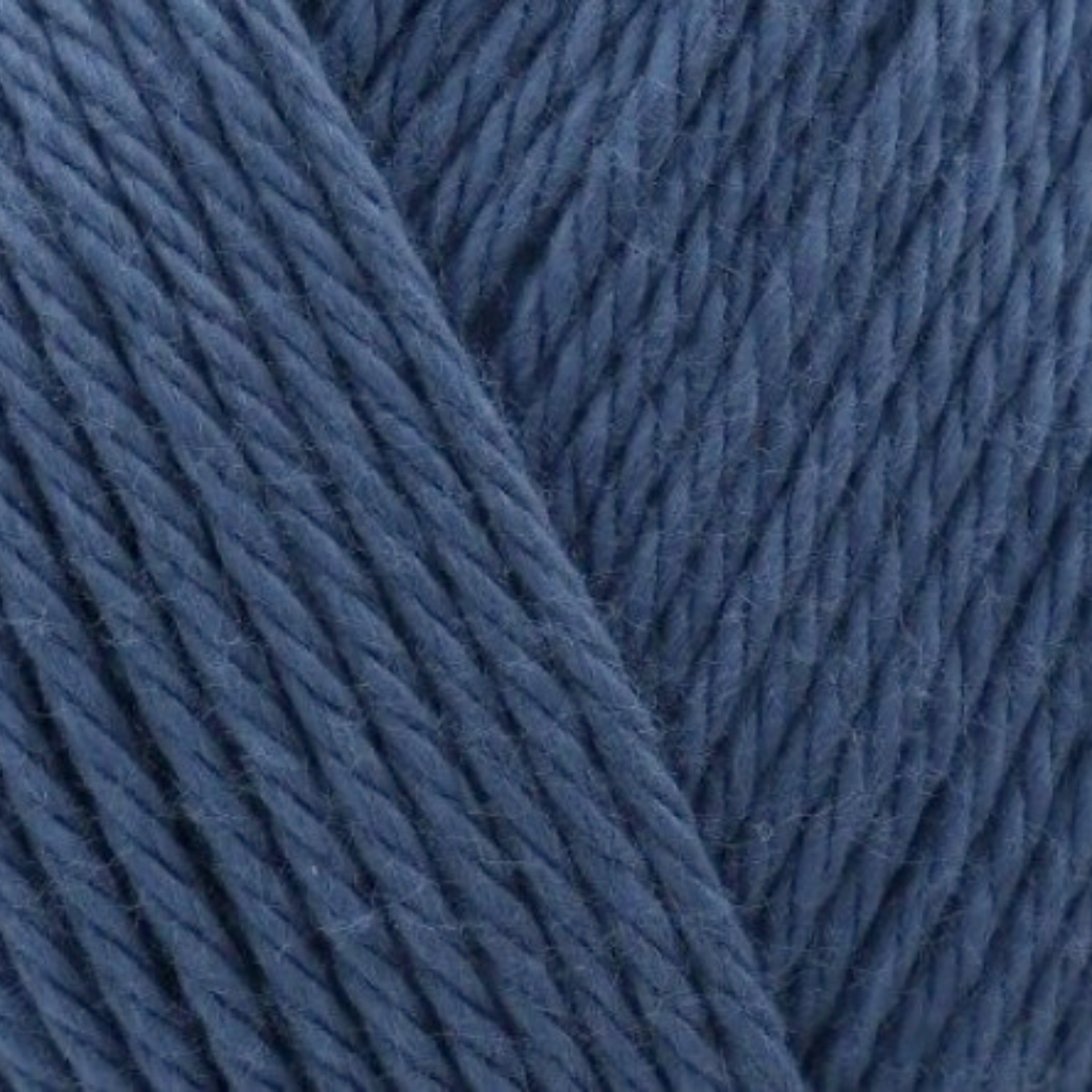 James C. Brett It’s Pure Cotton DK yarn Denim IC15, 100% cotton DK yarn texture in a soft mid-blue denim shade.
