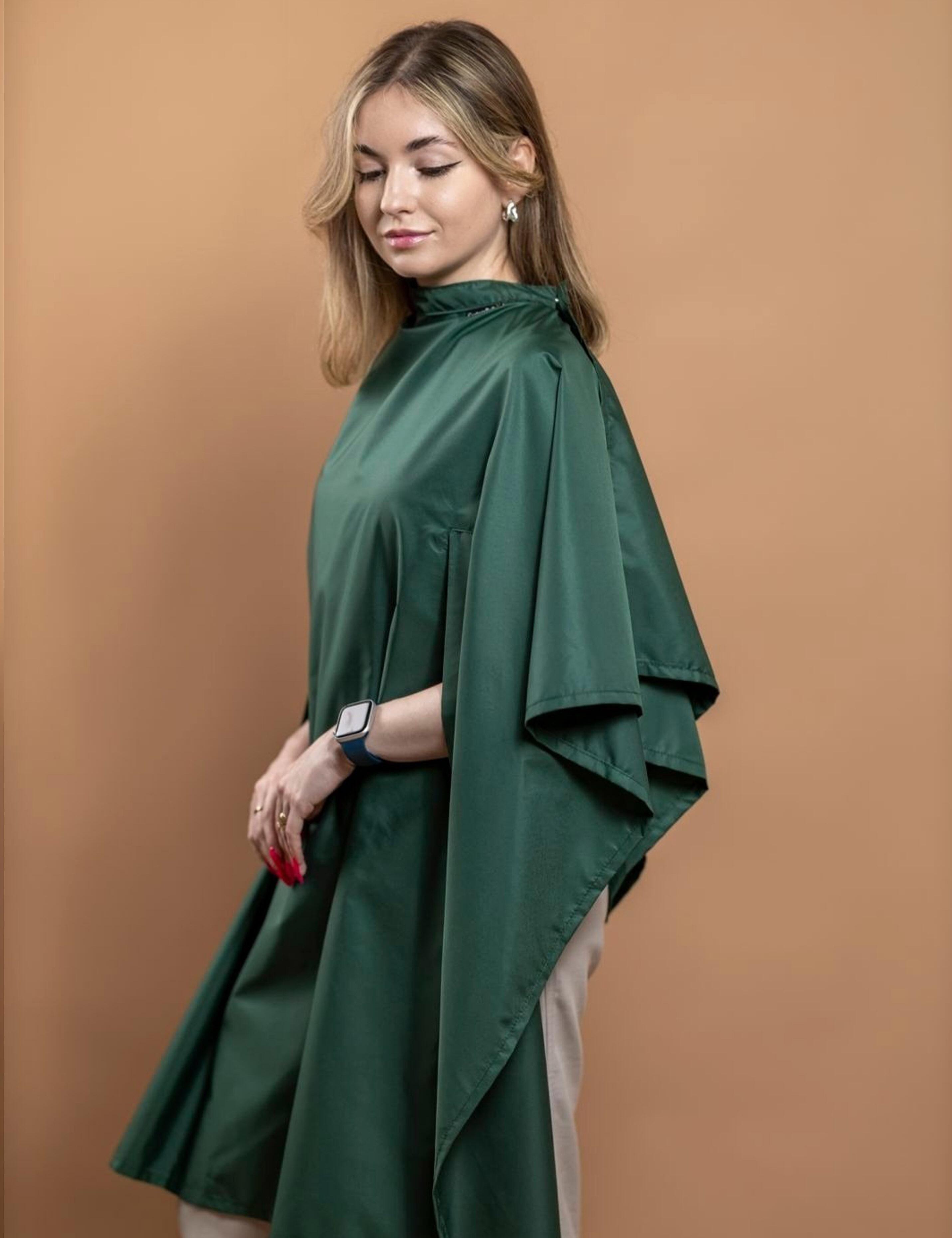 Dark green salon cape featuring convenient hand slits for phone use