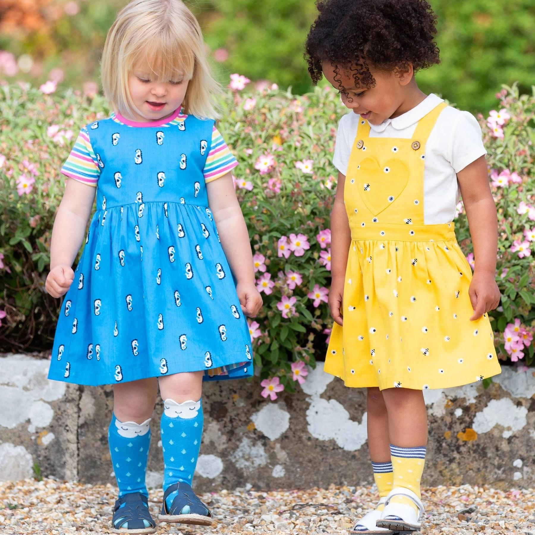 Girl wearing Kite Clothing Mini Honey Bee Pinafore with friend