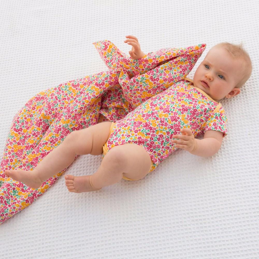 Baby wearing Kite Clothing Peony Bodysuit with matching blanket