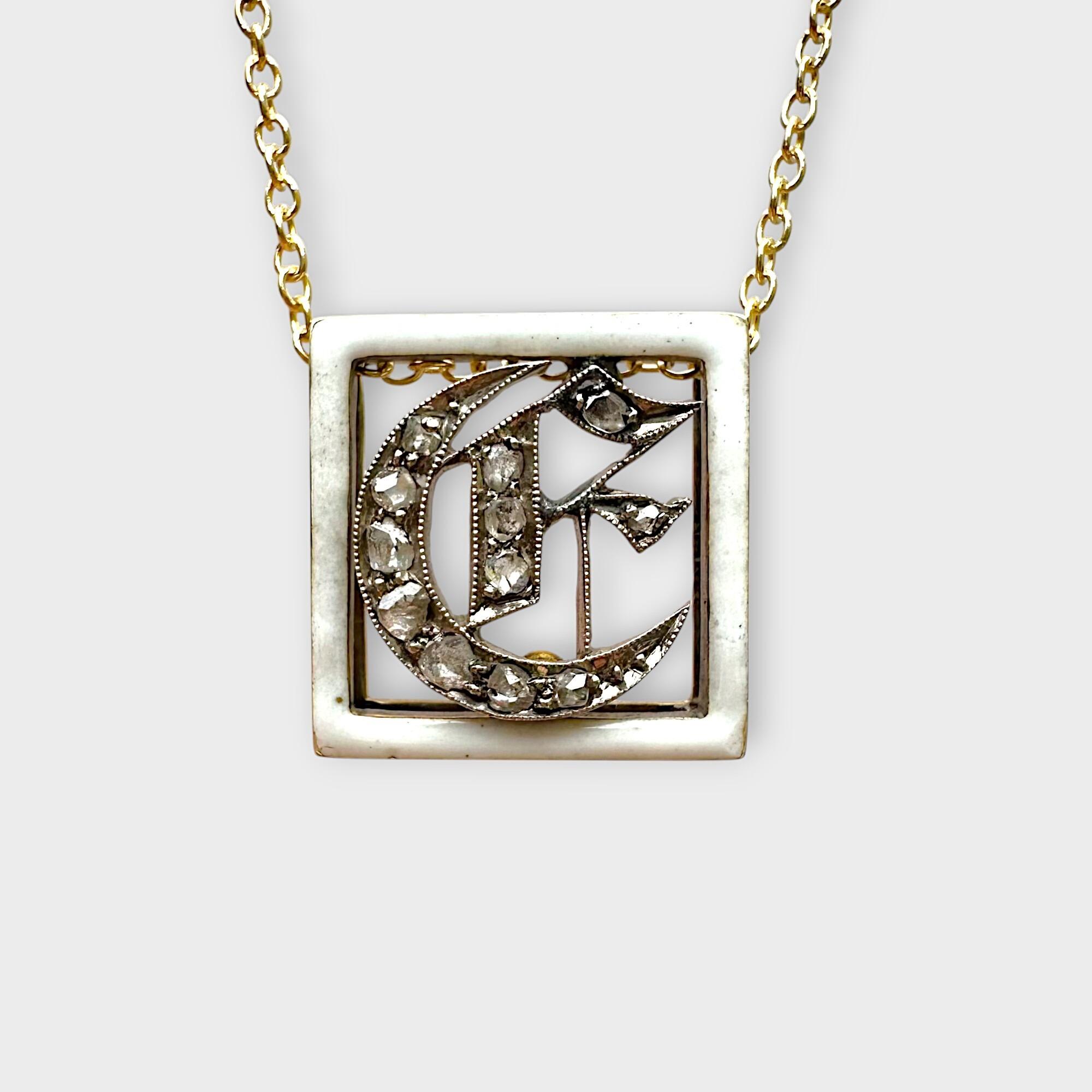 Victorian enamel and diamond monogram, initial buckle, slider pendant on grey background.