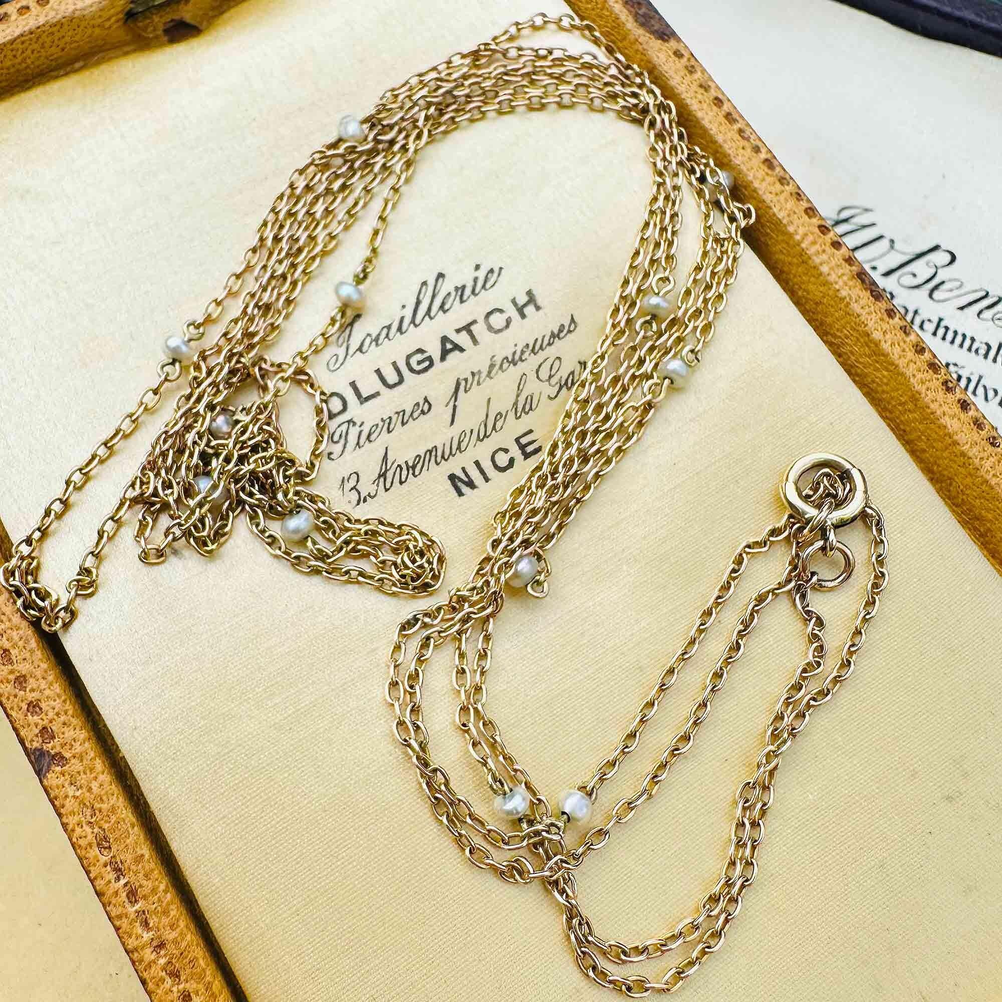 Antique 149cm gold pearl station muff chain with natural pearls, in antique box.